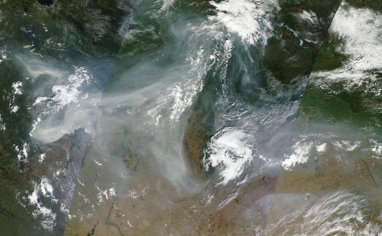NASA image acquired August 4, 2010 Intense fires continued to rage in western Russia on August 4, 2010. Burning in dry peat bogs and forests, the fires produced a dense plume of smoke that reached across hundreds of kilometers. The Moderate Resolution Imaging Spectroradiometer (MODIS) captured this view of the fires and smoke in three consecutive overpasses on NASA’s Terra satellite. The smooth gray-brown smoke hangs over the Russian landscape, completely obscuring the ground in places. The top image provides a close view of the fires immediately southeast of Moscow, while the lower image shows the full extent of the smoke plume. To read more about this image go to: <a href="http://earthobservatory.nasa.gov/IOTD/view.php?id=45046" rel="nofollow">earthobservatory.nasa.gov/IOTD/view.php?id=45046</a> NASA image courtesy Jeff Schmaltz, MODIS Rapid Response Team at NASA GSFC. <b><a href="http://www.nasa.gov/centers/goddard/home/index.html" rel="nofollow">NASA Goddard Space Flight Center</a></b> is home to the nation's largest organization of combined scientists, engineers and technologists that build spacecraft, instruments and new technology to study the Earth, the sun, our solar system, and the universe. <b>Follow us on <a href="http://twitter.com/NASA_GoddardPix" rel="nofollow">Twitter</a></b> <b>Join us on <a href="http://www.facebook.com/pages/Greenbelt-MD/NASA-Goddard/395013845897?ref=tsd" rel="nofollow">Facebook</a><b></b></b>