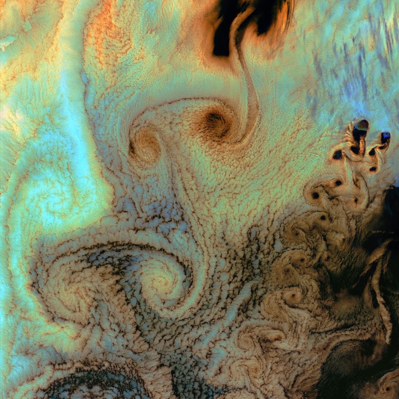 July 4th, 2002: Description: As air flows over and around objects in its path, spiraling eddies, known as Von Karman vortices, may form. The vortices in this image were created when prevailing winds sweeping east across the northern Pacific Ocean encountered Alaska’s Aleutian Islands. Source: Landsat 7 To learn more about the Landsat satellite go to: <a href="http://landsat.gsfc.nasa.gov/" rel="nofollow">landsat.gsfc.nasa.gov/</a>