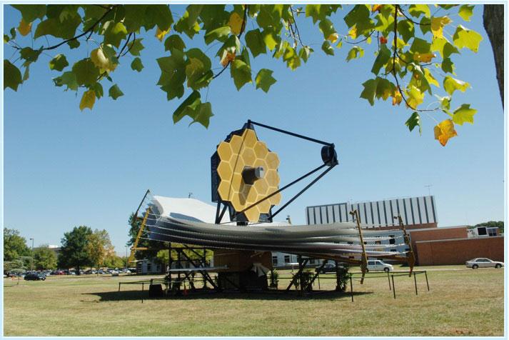 JWST Full-Scale Model on Display.  A full-scale model of the James Webb Space Telescope was built by the prime contractor, Northrop Grumman, to provide a better understanding of the size, scale and complexity of this satellite. The model is constructed mainly of aluminum and steel, weighs 12,000 lb., and is approximately 80 feet long, 40 feet wide and 40 feet tall. The model requires 2 trucks to ship it and assembly takes a crew of 12 approximately four days. This model has travelled to a few sites since 2005. The photographs below were taken at some of its destinations.   The model is pictured here in Greenbelt, MD at the NASA Goddard Space Flight Center.  Credit: NASA/Goddard Space Flight Center/Pat Izzo