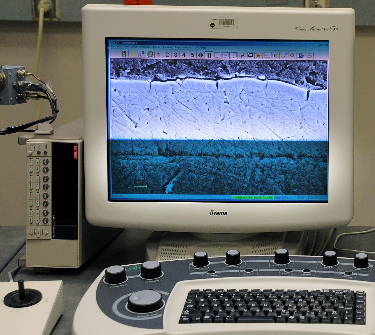 Analyzing a piece of the film that the History Detectives believed was from the Echo II Project.  PHOTO CREDIT: NASA/Debbie Mccallum