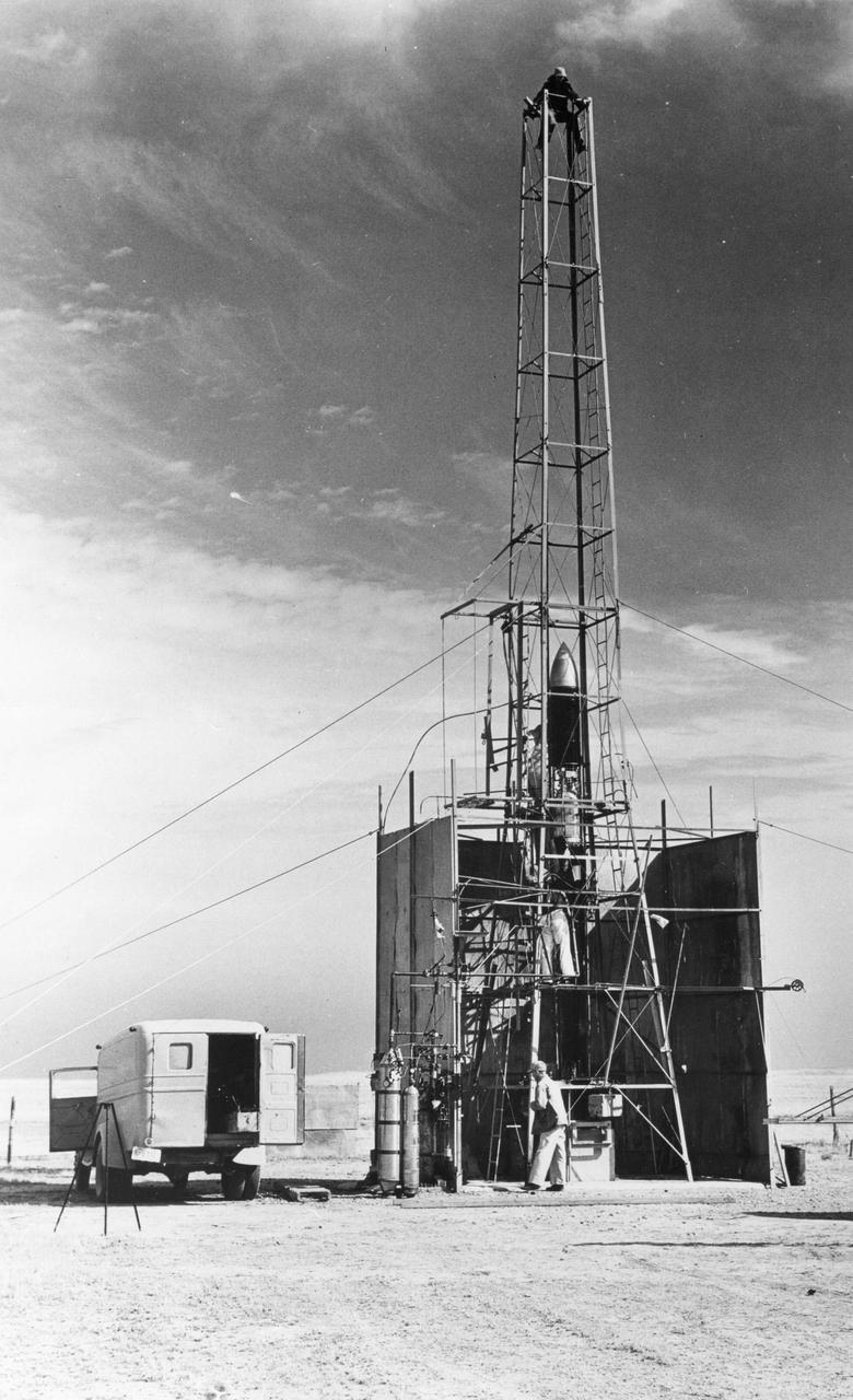 Dr. Robert Goddard's 22 foot rocket in it's launching tower, 1940, near Roswell, New Mexico. N.T. Ljungquist on the ground, A.W. Kisk working on rocket and C. Mansur at top of tower. <b><a href="http://www.nasa.gov/centers/goddard/home/index.html" rel="nofollow">NASA Goddard Space Flight Center</a></b> enables NASA’s mission through four scientific endeavors: Earth Science, Heliophysics, Solar System Exploration, and Astrophysics. Goddard plays a leading role in NASA’s accomplishments by contributing compelling scientific knowledge to advance the Agency’s mission. <b>Follow us on <a href="http://twitter.com/NASA_GoddardPix" rel="nofollow">Twitter</a></b> <b>Join us on <a href="http://www.facebook.com/pages/Greenbelt-MD/NASA-Goddard/395013845897?ref=tsd" rel="nofollow">Facebook</a></b>