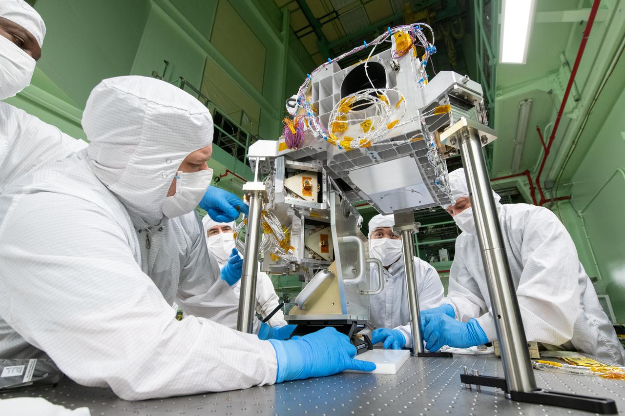 Mechanical technician, Andrew Scharmann, slides a lift fixture into position to ensure the Ocean Color Instrument (OCI) Main Optics Bench (MOB) and Main Optics Sub Bench (MOSB) are aligned.  OCI is a highly advanced optical spectrometer that will be used to measure properties of light over portions of the electromagnetic spectrum. It will enable continuous measurement of light at finer wavelength resolution than previous NASA satellite sensors, extending key system ocean color data records for climate studies. OCI is PACE's (Plankton, Aerosol, Cloud, ocean Ecosystem) primary sensor built at Goddard Space Flight Center in Greenbelt, MD.