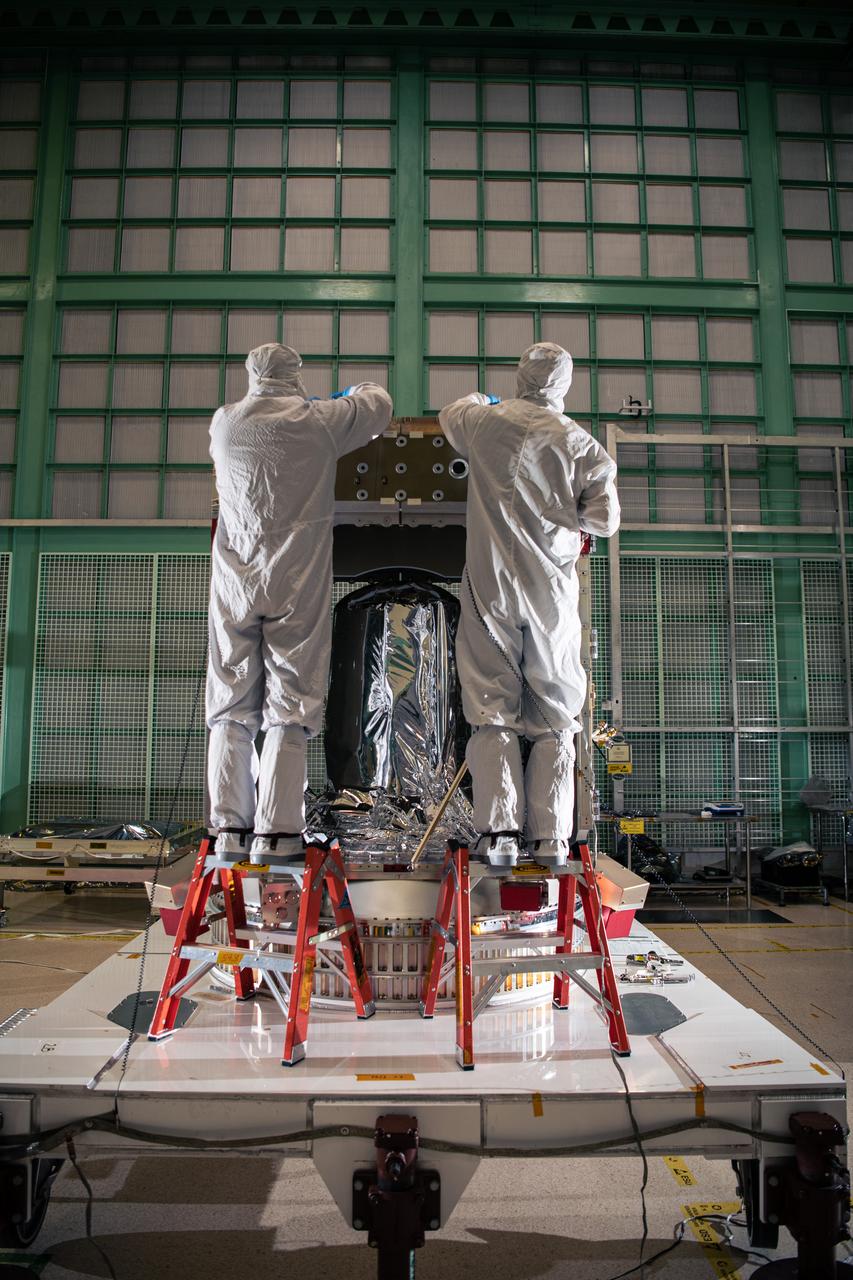 Engineering Technicians Alex Schaeffer and Eric Norris assemble the Plankton, Aerosol, Cloud, ocean Ecosystem (PACE) Spacecraft structure in the cleanroom at NASA Goddard Space Flight Center in Greenbelt, Maryland on February 24th, 2022. PACE's unprecedented spectral coverage will provide the first-ever global measurements designed to identify phytoplankton community composition. The mission will make global ocean color measurements, using the Ocean Color Instrument (OCI), to provide extended data records on ocean ecology and global biogeochemistry along with polarimetry measurements, using the Spectro-polarimeter for Planetary Exploration (SPEXone) and the Hyper Angular Research Polarimeter (HARP2) to provide extended data records on clouds and aerosols. The Earth-observing satellite mission, built at Goddard Space Flight Center in Greenbelt, MD, will continue and advance observations of global ocean color, biogeochemistry, and ecology, as well as the carbon cycle, aerosols and clouds.