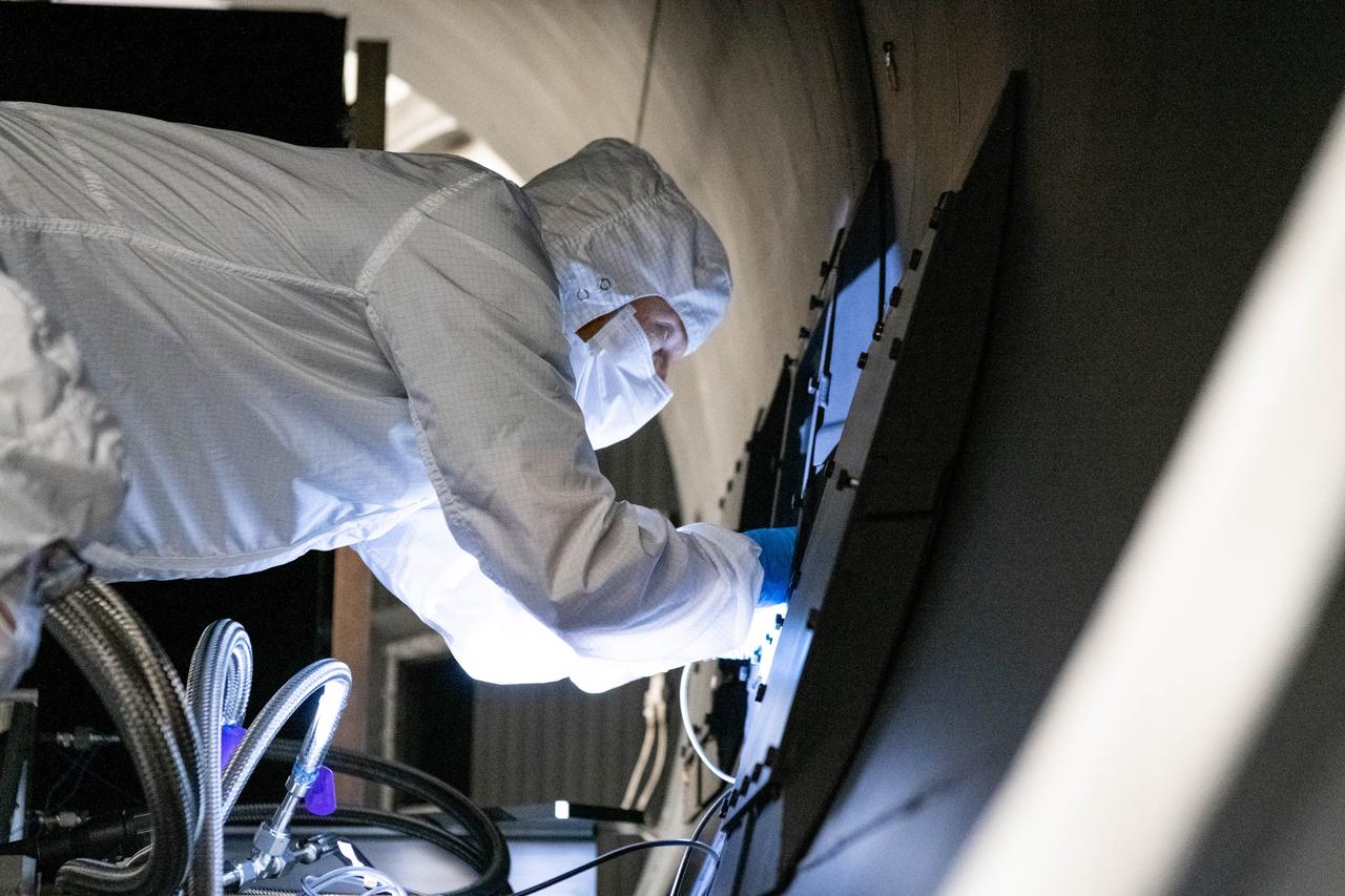Optical engineer, Brendan McAndrew, installs radiometers inside the Ocean Color Instrument (OCI) thermal vacuum chamber in preparation for window calibration testing. The testing will help scientists and engineers know if the optical components of OCI are aligned correctly before it gets integrated to the PACE (Plankton, Aerosol, Cloud, ocean Ecosystem) spacecraft.   OCI is a highly advanced optical spectrometer that will be used to measure properties of light over portions of the electromagnetic spectrum. It will enable continuous measurement of light at finer wavelength resolution than previous NASA satellite sensors, extending key system ocean color data records for climate studies. OCI is PACE's (Plankton, Aerosol, Cloud, ocean Ecosystem) primary sensor built at Goddard Space Flight Center in Greenbelt, MD.