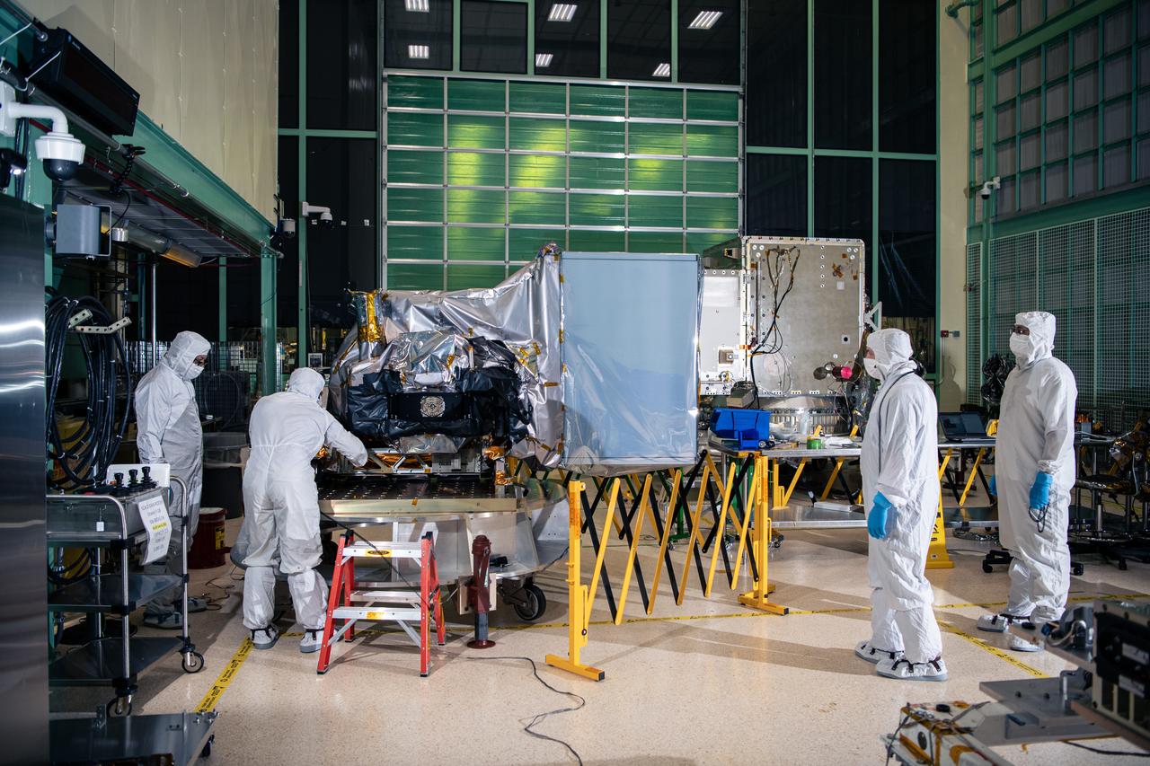 Engineers and technicians prepare for a crane lift to deintegrate the Ocean Color Instrument (OCI) from the Tilt Mechanism after successful environmental testing. The PACE (Plankton, Aerosol, Cloud, ocean Ecosystem) spacecraft is seen in the background in the Spacecraft Checkout Area (SCA) cleanroom.  OCI is a highly advanced optical spectrometer that will be used to measure properties of light over portions of the electromagnetic spectrum. It will enable continuous measurement of light at finer wavelength resolution than previous NASA satellite sensors, extending key system ocean color data records for climate studies. OCI is PACE's (Plankton, Aerosol, Cloud, ocean Ecosystem) primary sensor built at Goddard Space Flight Center in Greenbelt, MD.