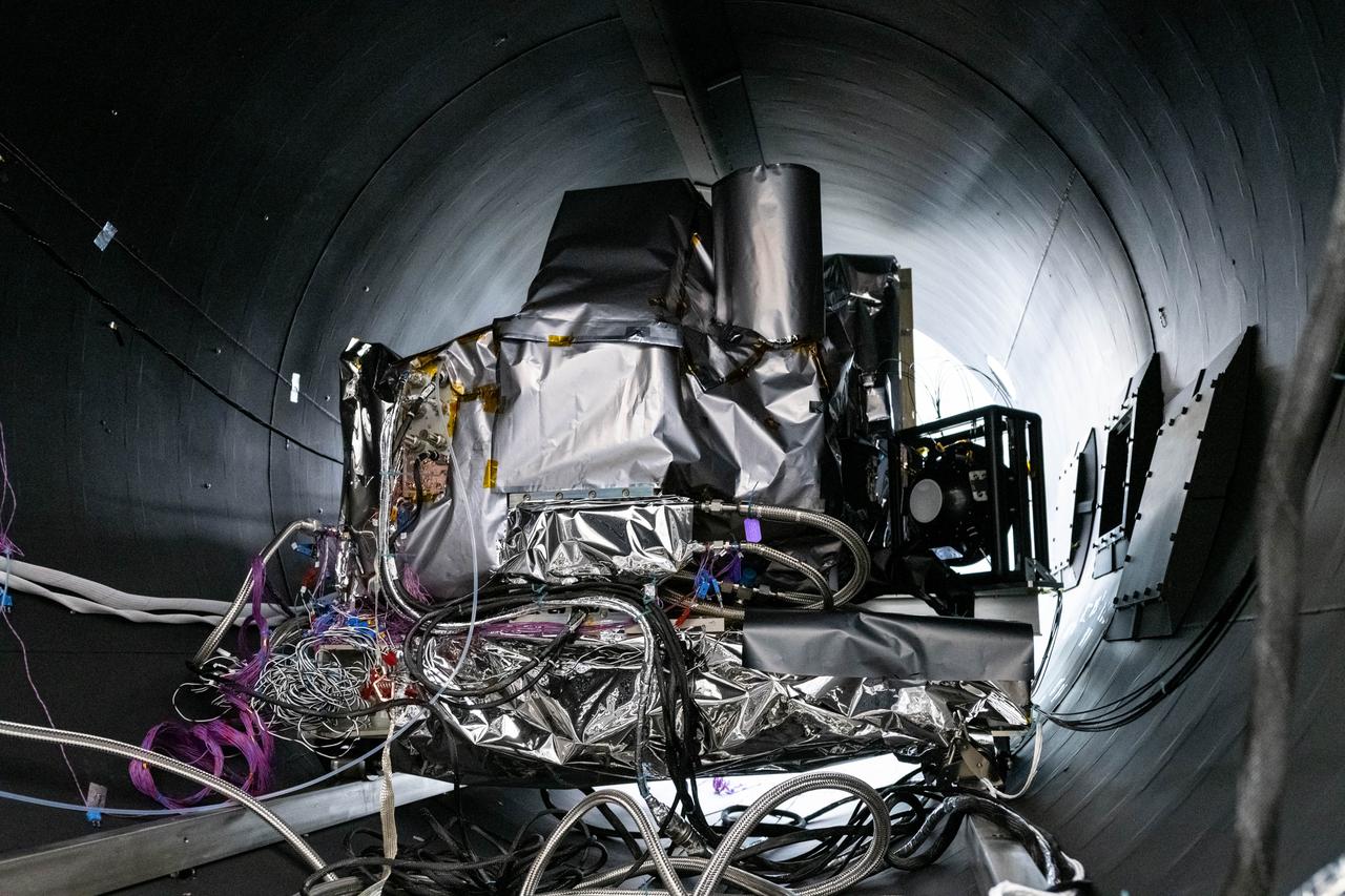 The flight Ocean Color Instrument (OCI) is connected to flex lines and other alignment calibration hardware in a thermal vacuum chamber as it is prepared for thermal testing in a clean tent at Goddard Space Flight Center in Greenbelt, MD.  OCI is a highly advanced optical spectrometer that will be used to measure properties of light over portions of the electromagnetic spectrum. It will enable continuous measurement of light at finer wavelength resolution than previous NASA satellite sensors, extending key system ocean color data records for climate studies. OCI is PACE's (Plankton, Aerosol, Cloud, ocean Ecosystem) primary sensor built at Goddard Space Flight Center in Greenbelt, MD.