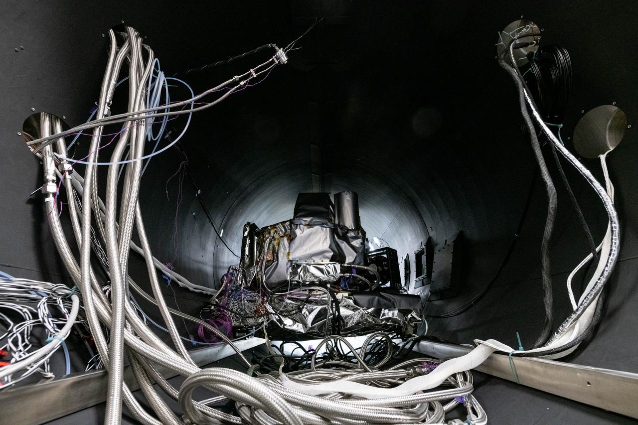 The flight Ocean Color Instrument (OCI) is connected to flex lines and other alignment calibration hardware in a thermal vacuum chamber as it is prepared for thermal testing in a clean tent at Goddard Space Flight Center in Greenbelt, MD.  OCI is a highly advanced optical spectrometer that will be used to measure properties of light over portions of the electromagnetic spectrum. It will enable continuous measurement of light at finer wavelength resolution than previous NASA satellite sensors, extending key system ocean color data records for climate studies. OCI is PACE's (Plankton, Aerosol, Cloud, ocean Ecosystem) primary sensor built at Goddard Space Flight Center in Greenbelt, MD.