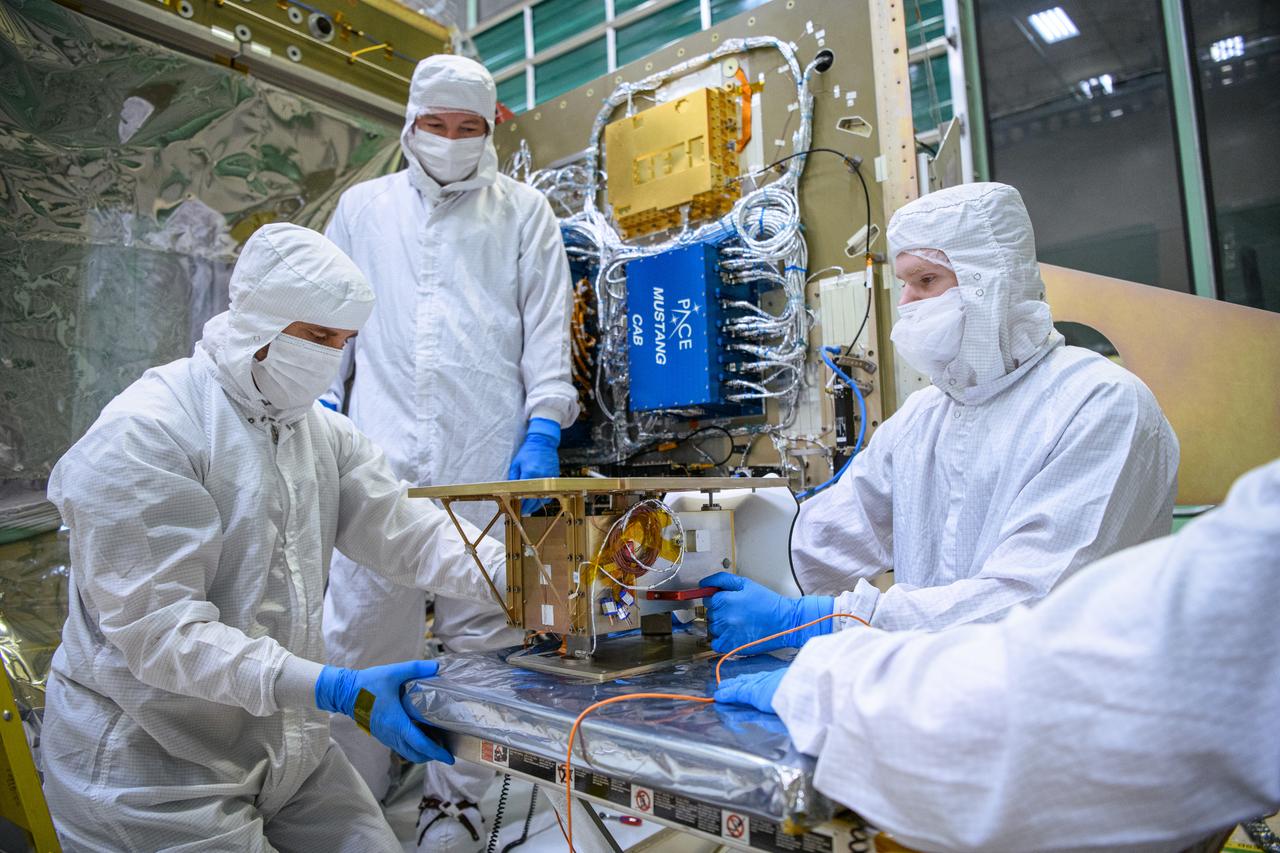 Technicians prepare to integrate the Hyper-Angular Rainbow Polarimeter #2 (HARP2) instrument to the Plankton, Aerosol, Cloud, ocean Ecosystem (PACE) spacecraft bus at NASA's Goddard Space Flight Center in Greenbelt, Maryland on October 25th, 2022. HARP2 is one of three instruments on NASA's PACE observatory, it was designed and built by UMBC's Earth and Space Institute. PACE's unprecedented spectral coverage will provide the first-ever global measurements designed to identify phytoplankton community composition. The mission will make global ocean color measurements, using the Ocean Color Instrument (OCI), to provide extended data records on ocean ecology and global biogeochemistry along with polarimetry measurements, using the Spectro-polarimeter for Planetary Exploration (SPEXone) and the Hyper Angular Research Polarimeter (HARP2) to provide extended data records on clouds and aerosols. The Earth-observing satellite mission, built at Goddard Space Flight Center in Greenbelt, MD, will continue and advance observations of global ocean color, biogeochemistry, and ecology, as well as the carbon cycle, aerosols and clouds.
