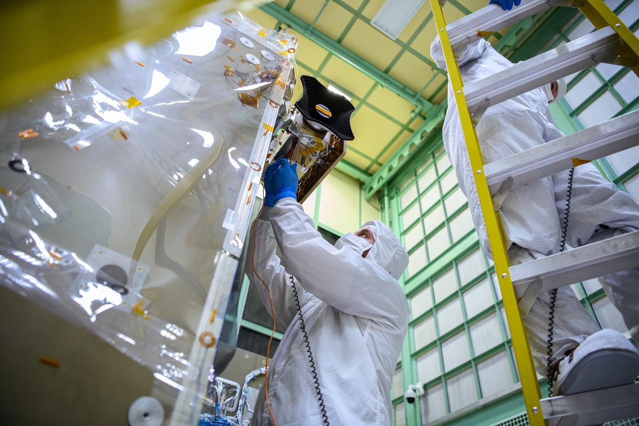 Technicians integrate the Hyper-Angular Rainbow Polarimeter #2 (HARP2) instrument to the Plankton, Aerosol, Cloud, ocean Ecosystem (PACE) spacecraft bus at NASA's Goddard Space Flight Center in Greenbelt, Maryland on October 25th, 2022. HARP2 is one of three instruments on NASA's PACE observatory, it was designed and built by UMBC's Earth and Space Institute. PACE's unprecedented spectral coverage will provide the first-ever global measurements designed to identify phytoplankton community composition. The mission will make global ocean color measurements, using the Ocean Color Instrument (OCI), to provide extended data records on ocean ecology and global biogeochemistry along with polarimetry measurements, using the Spectro-polarimeter for Planetary Exploration (SPEXone) and the Hyper Angular Research Polarimeter (HARP2) to provide extended data records on clouds and aerosols. The Earth-observing satellite mission, built at Goddard Space Flight Center in Greenbelt, MD, will continue and advance observations of global ocean color, biogeochemistry, and ecology, as well as the carbon cycle, aerosols and clouds.