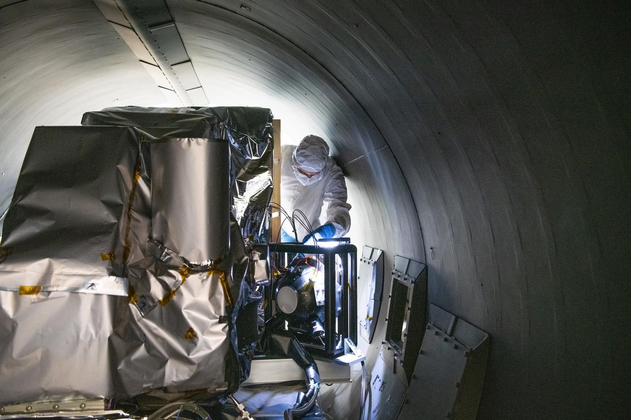 Engineer, Joe Thomes, disconnects the Multi-Lens Array fibers from the Ocean Color Instrument (OCI) in the thermal vacuum chamber after  successful thermal testing. OCI is a highly advanced optical spectrometer that will be used to measure properties of light over portions of the electromagnetic spectrum. It will enable continuous measurement of light at finer wavelength resolution than previous NASA satellite sensors, extending key system ocean color data records for climate studies. OCI is PACE's (Plankton, Aerosol, Cloud, ocean Ecosystem) primary sensor built at Goddard Space Flight Center in Greenbelt, MD.