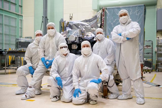 NASA image: OCI Mechanical Technician Team Pose with the Integrated Earth Shade
