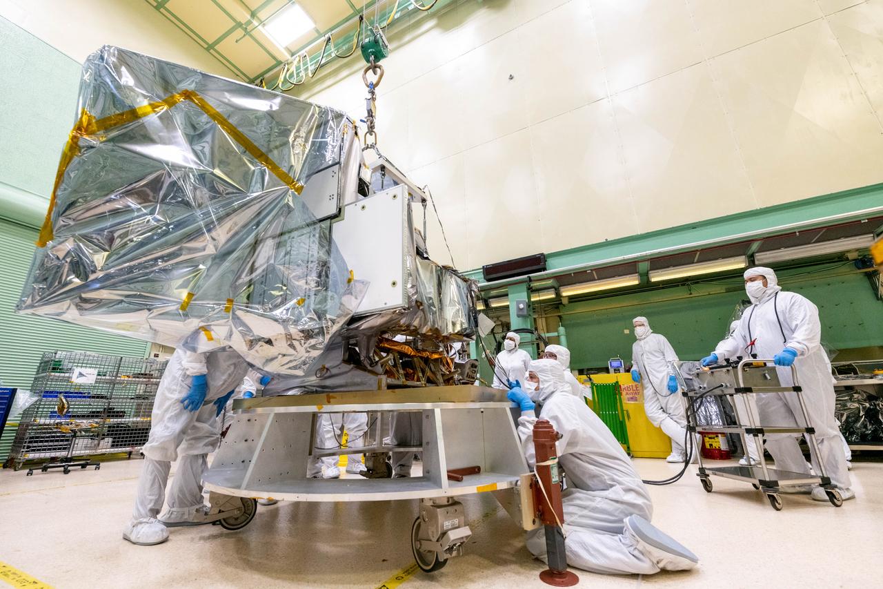 Mechanical technicians crane lift the Ocean Color Instrument (OCI) onto the Tilt Mechanism. OCI is a highly advanced optical spectrometer that will be used to measure properties of light over portions of the electromagnetic spectrum. It will enable continuous measurement of light at finer wavelength resolution than previous NASA satellite sensors, extending key system ocean color data records for climate studies. OCI is PACE's (Plankton, Aerosol, Cloud, ocean Ecosystem) primary sensor built at Goddard Space Flight Center in Greenbelt, MD.