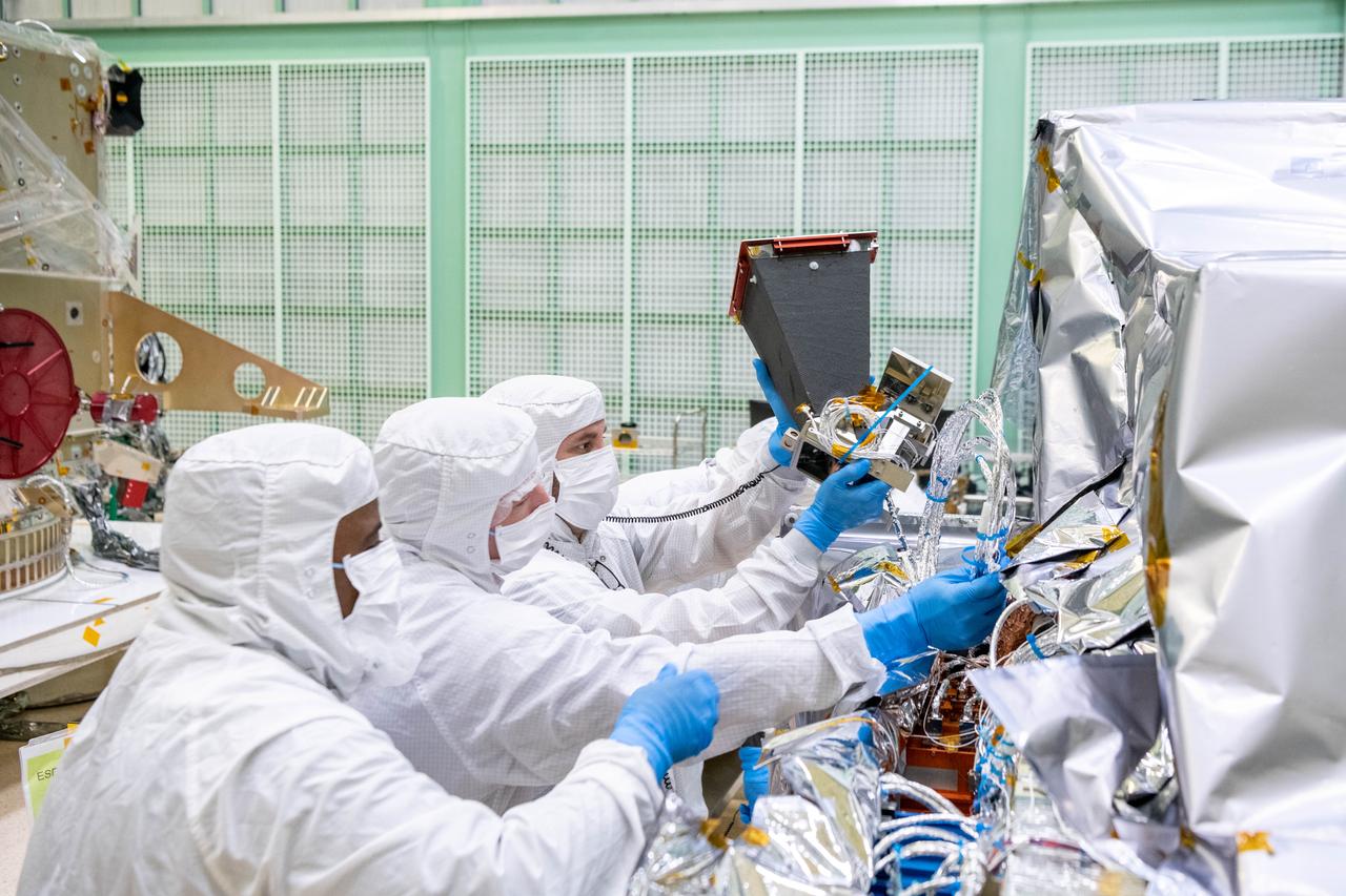 Engineer, Marton Sharpe, and mechanical technicians, Alexander Schaeffer and Eric Norris, install the Star Tracker to the Ocean Color Instrument (OCI) prior to integration to the Plankton, Aerosol, Cloud, ocean Ecosystem (PACE) spacecraft. The Star Tracker is a specially designed sextant to measure the angle between different celestial bodies in relation to each other or the horizon. This is important not just for navigation but for providing better images and science data. OCI is a highly advanced optical spectrometer that will be used to measure properties of light over portions of the electromagnetic spectrum. It will enable continuous measurement of light at finer wavelength resolution than previous NASA satellite sensors, extending key system ocean color data records for climate studies. OCI is PACE's primary sensor built at Goddard Space Flight Center in Greenbelt, MD.