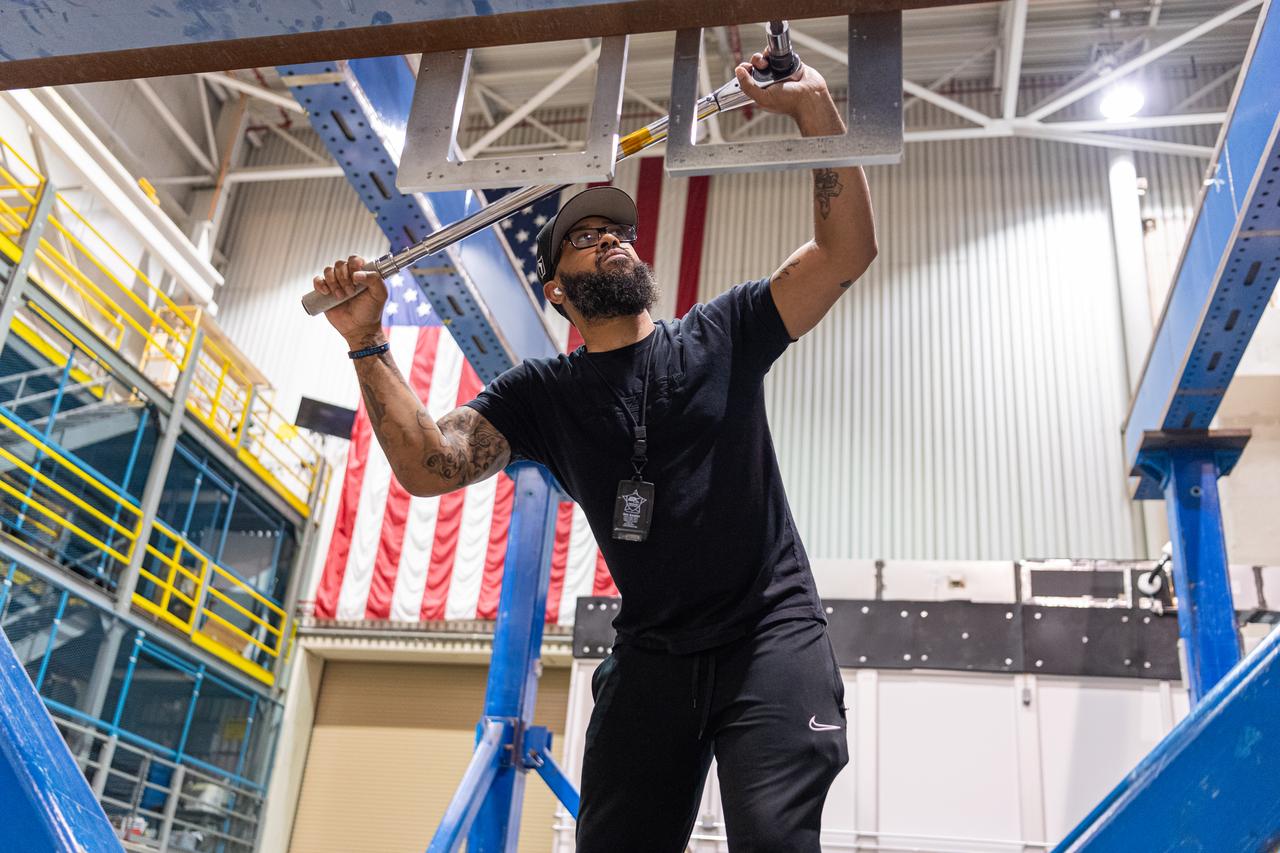 Mechanical engineering and integration technician Ivan Pratt installs brackets onto the static load testing platform in preparation of an OSAM-1 ground support equipment proof test at Goddard Space Flight Center, Greenbelt Md., July 19, 2023. This photo has been reviewed by OSAM1 project management and the Export Control Office and is released for public view. NASA/Mike Guinto