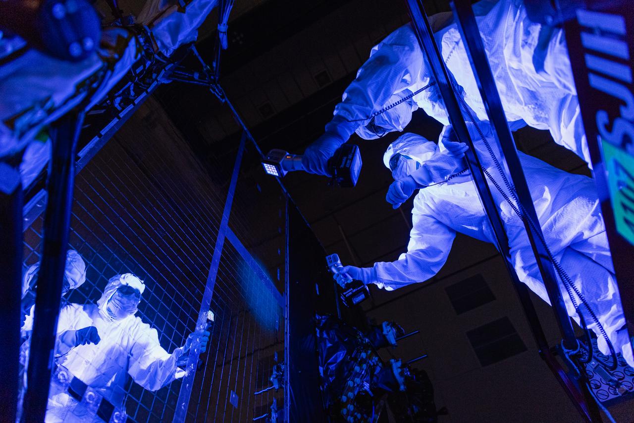 NASA Contamination control engineers perform a blacklight inspection on the OSAM-1 Spacecraft Bus at Goddard Space Flight Center, Greenbelt Md., Sept 30, 2023. This photo has been reviewed by OSAM1 project management, Maxar public release authority, and the Export Control Office and is released for public view. NASA/Mike Guinto