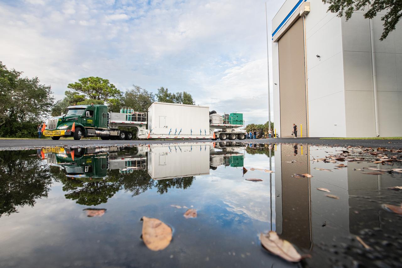 The transport carrier containing NASA’s Plankton, Aerosol, Cloud, ocean Ecosystem (PACE) observatory spacecraft arrives at the Astrotech Space Operations Facility near the agency’s Kennedy Space Center in Florida on Tuesday, Nov. 14, 2023. PACE was shipped from the agency’s Goddard Space Flight Center in Greenbelt, Maryland, and is targeted to launch on January 30, 2024, on a SpaceX Falcon 9 rocket lifting off from Space Launch Complex 40 at Cape Canaveral Space Force Station. The PACE observatory will help us better understand how the ocean and atmosphere exchange carbon dioxide, measure key atmospheric variables associated with air quality and Earth's climate, and monitor ocean health, in part by studying phytoplankton, tiny plants and algae that sustain the marine food web.