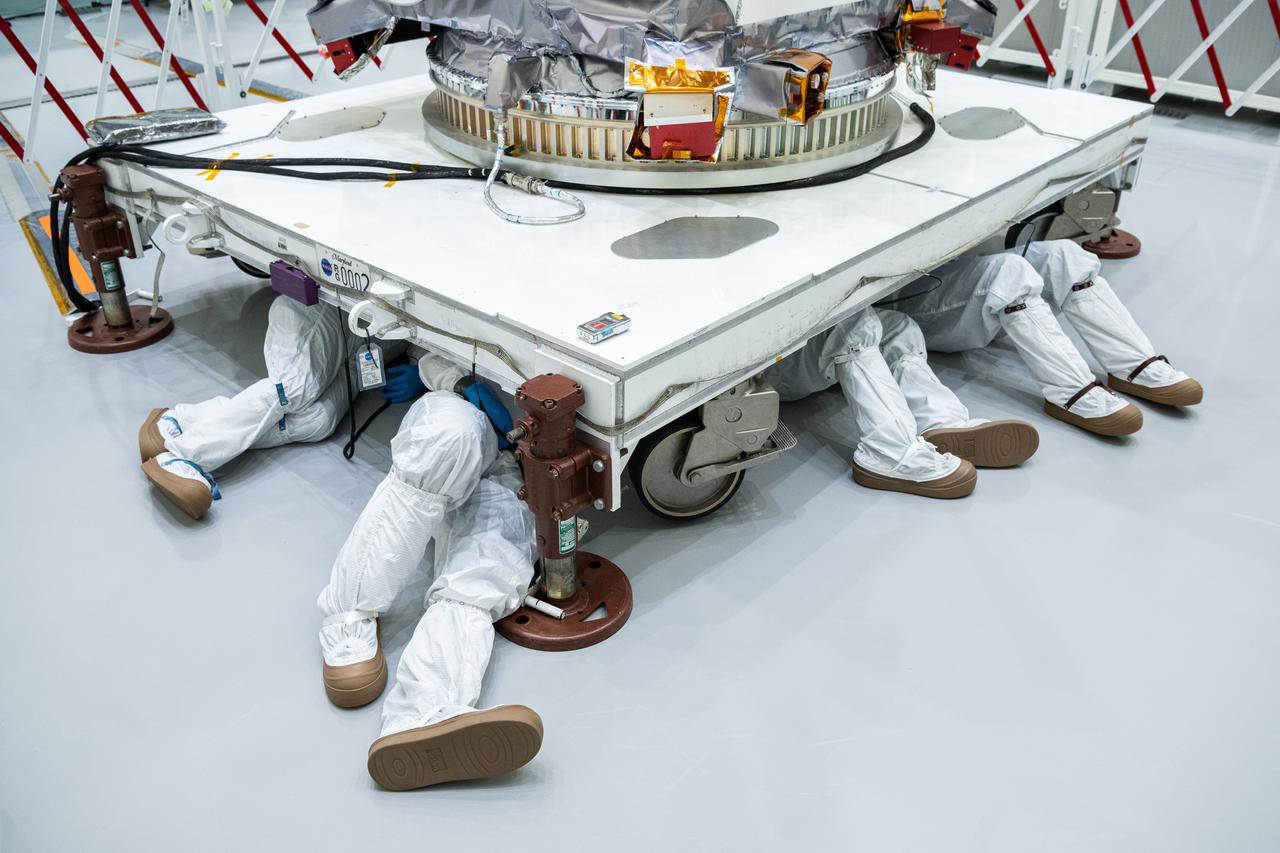 Engineers and Technicians from NASA’s Goddard Space Flight Center crawl under the PACE (Plankton, Aerosol, Cloud, ocean Ecosystem) spacecraft to inspect the +X side during payload processing at Astrotech Space Operations in Titusville, FL on January 27th, 2024.