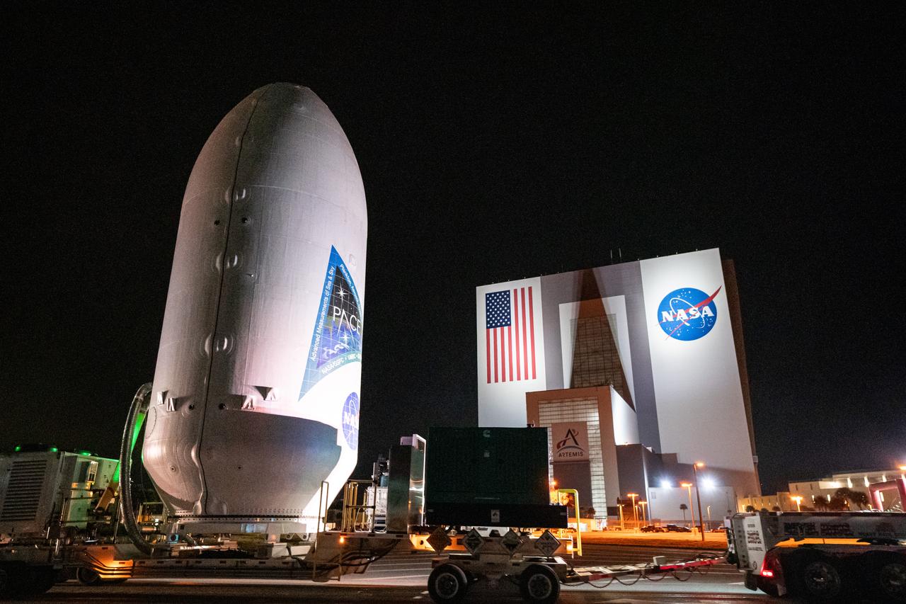 NASA’s PACE (Plankton, Aerosol, Cloud, ocean Ecosystem) spacecraft encapsulated inside SpaceX’s Falcon 9 payload fairings is transported from the Astrotech Space Operations Facility near the agency’s Kennedy Space Center in Florida to Space Launch Complex 40 at Cape Canaveral Space Force Station on Thursday, Feb. 1, 2024, to be mated with a SpaceX Falcon 9 in preparation for liftoff set for no earlier than 1:33 a.m. EST on Tuesday, Feb. 6, 2024. PACE is NASA’s newest earth-observing satellite that will help increase our understanding of Earth’s oceans, atmosphere, and climate by delivering hyperspectral observations of microscopic marine organisms called phytoplankton as well new data on clouds and aerosols.