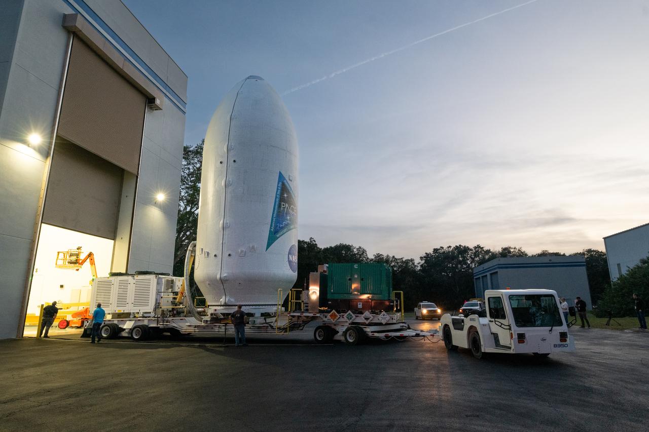 NASA’s PACE (Plankton, Aerosol, Cloud, ocean Ecosystem) spacecraft encapsulated inside SpaceX’s Falcon 9 payload fairings is transported from the Astrotech Space Operations Facility near the agency’s Kennedy Space Center in Florida to Space Launch Complex 40 at Cape Canaveral Space Force Station on Thursday, Feb. 1, 2024, to be mated with a SpaceX Falcon 9 in preparation for liftoff set for no earlier than 1:33 a.m. EST on Tuesday, Feb. 6, 2024. PACE is NASA’s newest earth-observing satellite that will help increase our understanding of Earth’s oceans, atmosphere, and climate by delivering hyperspectral observations of microscopic marine organisms called phytoplankton as well new data on clouds and aerosols.