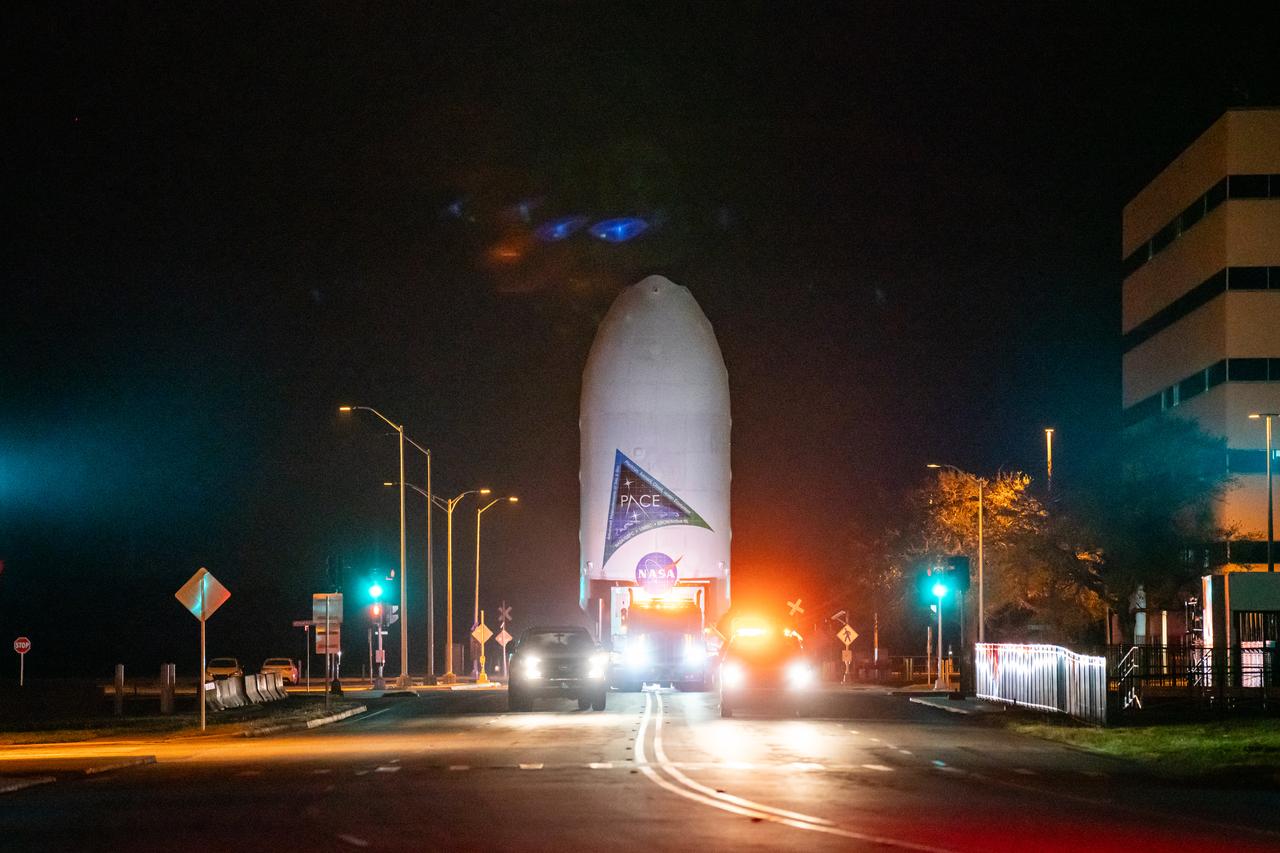NASA’s PACE (Plankton, Aerosol, Cloud, ocean Ecosystem) spacecraft encapsulated inside SpaceX’s Falcon 9 payload fairings is transported from the Astrotech Space Operations Facility near the agency’s Kennedy Space Center in Florida to Space Launch Complex 40 at Cape Canaveral Space Force Station on Thursday, Feb. 1, 2024, to be mated with a SpaceX Falcon 9 in preparation for liftoff set for no earlier than 1:33 a.m. EST on Tuesday, Feb. 6, 2024. PACE is NASA’s newest earth-observing satellite that will help increase our understanding of Earth’s oceans, atmosphere, and climate by delivering hyperspectral observations of microscopic marine organisms called phytoplankton as well new data on clouds and aerosols.
