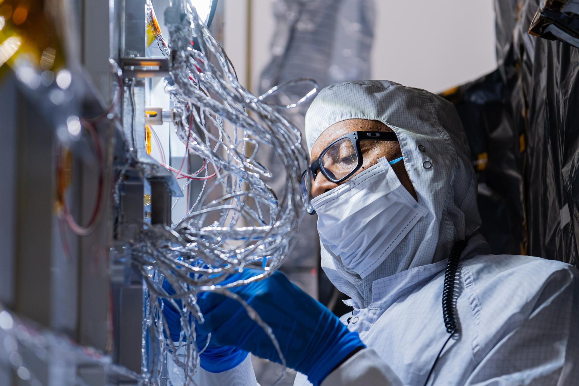 OSAM-1 Electrical Engineer Gregory Griffin tapes hardware on the underside of the OSAM-1 Servicing Payload inside cleanroom at Goddard Space Flight Center, Greenbelt Md., Aug 19, 2024. This photo has been reviewed by the Export Control Office, project Management, and Maxar release authority and is released for public view. NASA/Mike Guinto