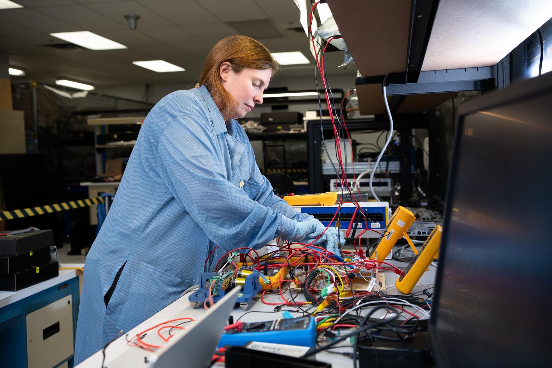 Rebekah Austin, Avionics Lead and Deputy Systems Engineer, configures a breadboard test for the Lunar Environment Monitoring Station (LEMS) Seismometer at NASA's Goddard Space Flight Center in Greenbelt, Maryland on May 14th, 2025. NASA/Denny Henry