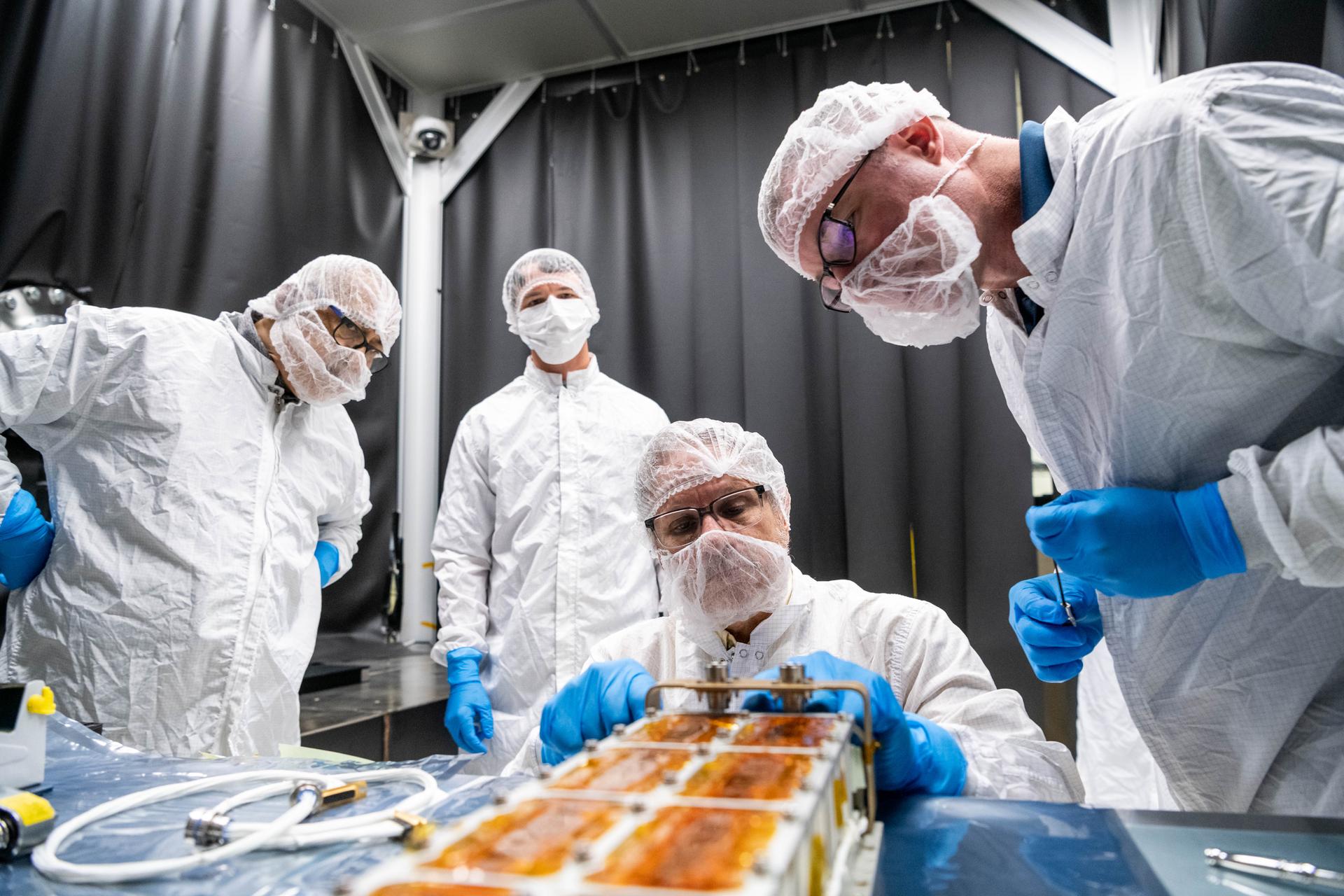 Lunar Environment Monitoring Station (LEMS) team members assemble the flight battery connectors to the connector bracket in a lab at Goddard Space Flight Center in Greenbelt, Maryland on September 9th, 2025. LEMS is a compact, autonomous, and self-sustaining seismometer suite designed to carry out continuous, long-term, monitoring of the lunar seismic environment at the South Polar region. NASA/Katie Mellos. 
