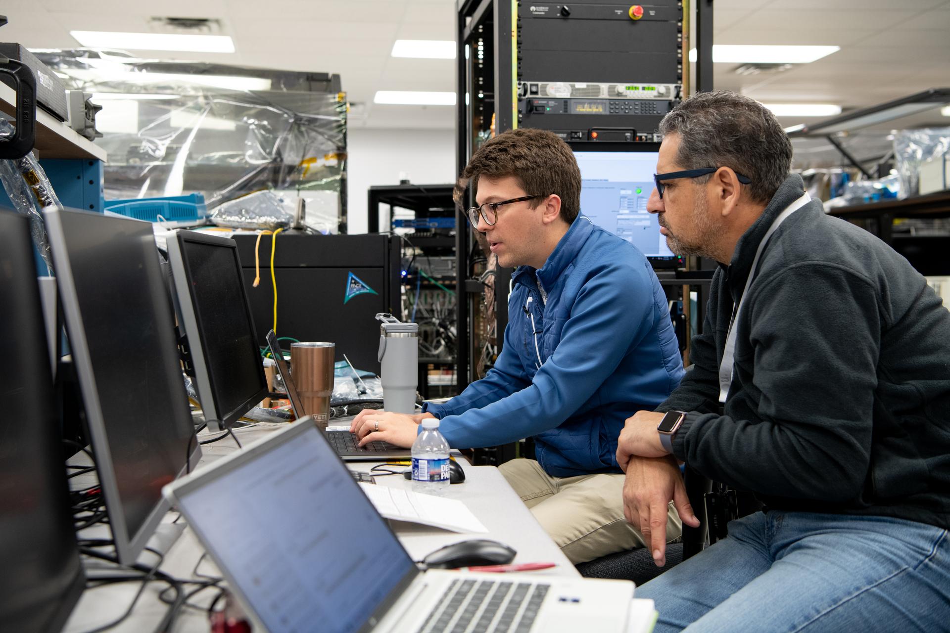 Lunar Environment Monitoring Station (LEMS) team members Computer Engineer James Olsen & Principle Investigator Dr. Medhi Benna perform electrical test procedures in the avoinics lab at at Goddard Space Flight Center in Greenbelt, Maryland. LEMS is a compact, autonomous, and self-sustaining seismometer suite designed to carry out continuous, long-term, monitoring of the lunar seismic environment at the South Polar region.NASA/Desiree Stover. 