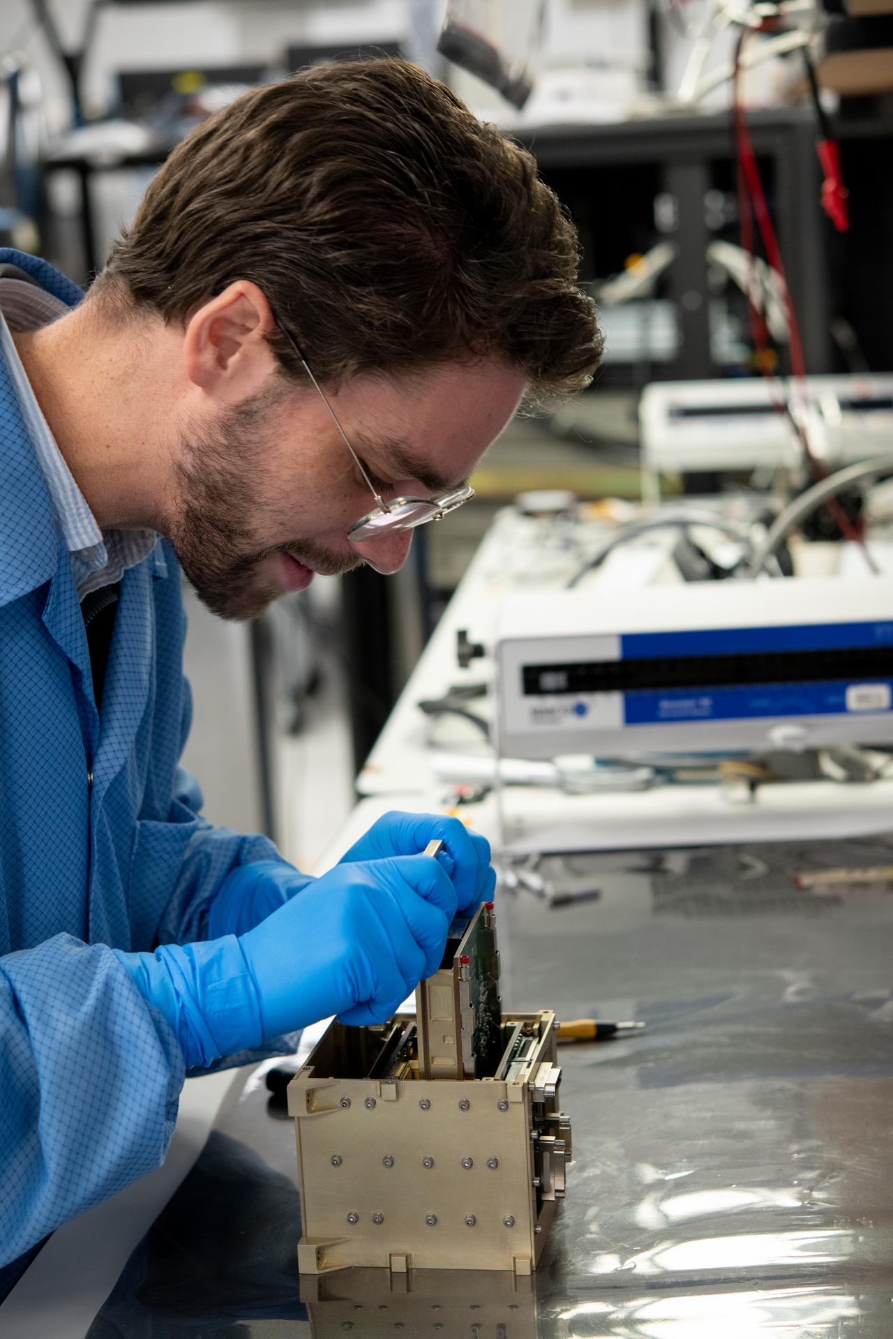 Mechanical Engineer Mitchell Hamann disassembles a Lunar Environment Monitoring Station (LEMS) flight electrical board chassis in the avoinics lab at NASA's Goddard Space Flight Center in Greenbelt, Maryland on October 22, 2025. LEMS is a compact, autonomous, and self-sustaining seismometer suite designed to carry out continuous, long-term, monitoring of the lunar seismic environment at the South Polar region. NASA/Desiree Stover. 