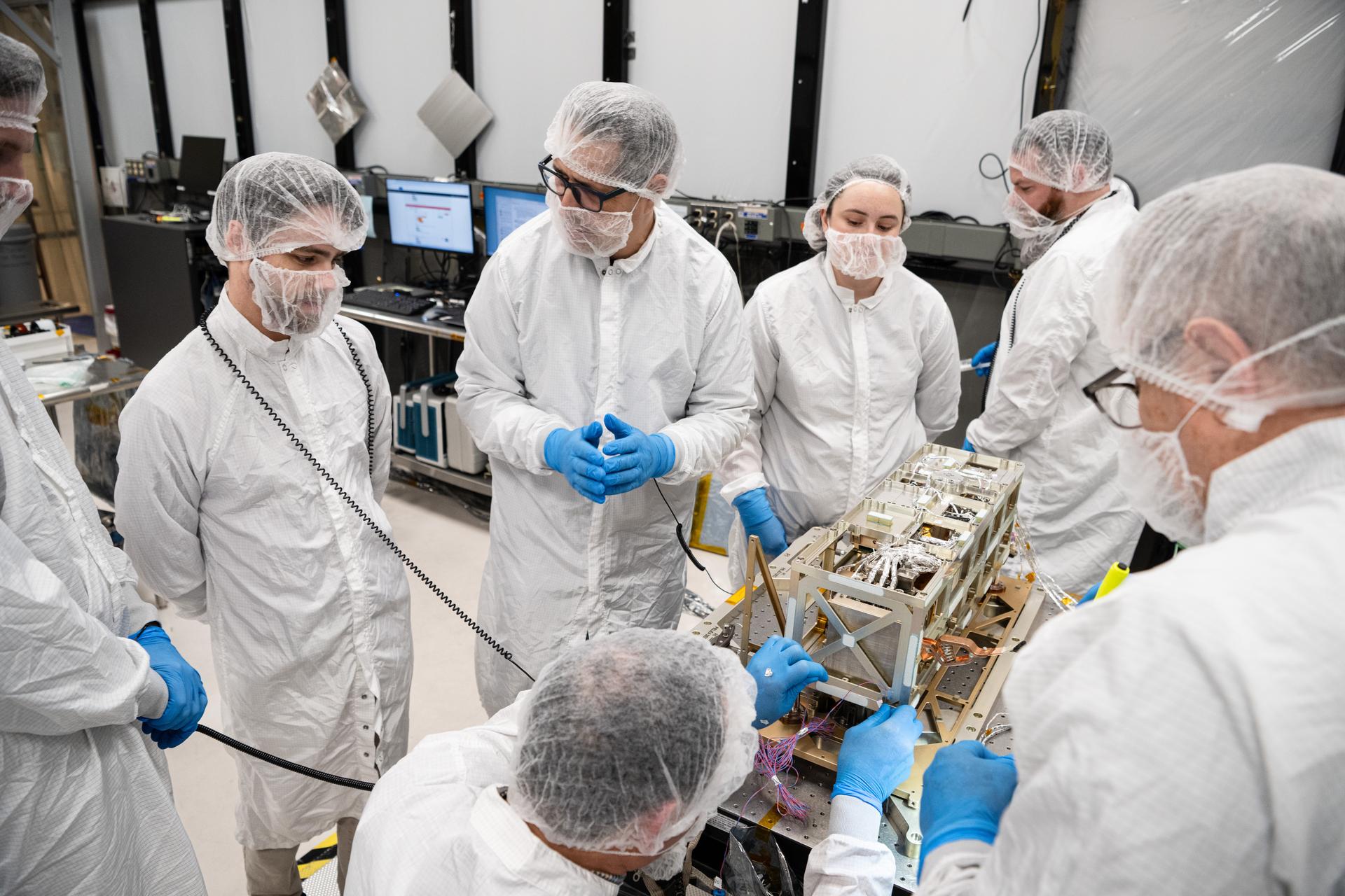 Engineers and technicians inspect the Lunar Environment Monitoring Station (LEMS) instrument in the cleanroom at Goddard Space Flight Center in Greenbelt Md. on January 9th 2026. LEMS is a compact, autonomous, and self-sustaining seismometer suite designed to carry out continuous, long-term, monitoring of the lunar seismic environment at the South Polar region. Photo Credit: NASA/Denny Henry 