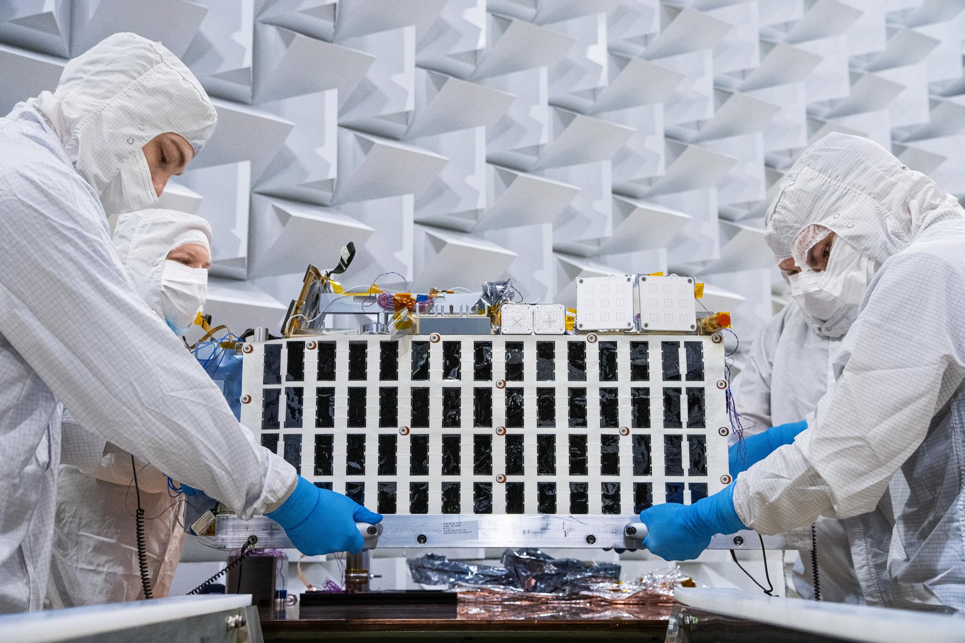 Lunar Environment Monitoring Station (LEMS) team members install the instrument for testing in the Electromagnetic Interference/Electromagnetic Compatibility (EMI/EMC) Chamber at Goddard Space Flight Center, Greenbelt Md., Feb 13, 2026. LEMS is a compact, autonomous, and self-sustaining seismometer suite designed to carry out continuous, long-term, monitoring of the lunar seismic environment at the South Polar region. Photo Credit: NASA/Denny Henry