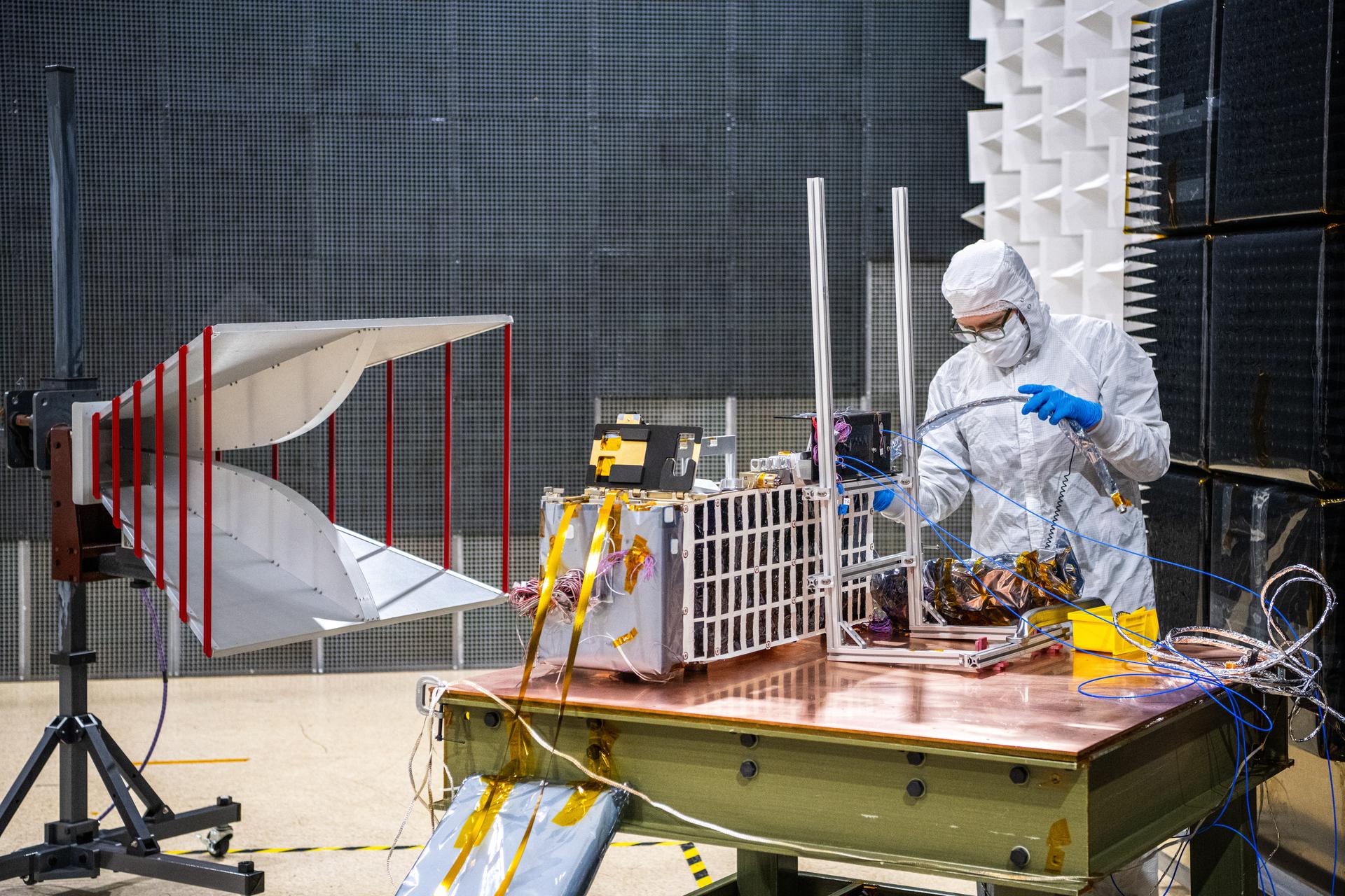 Electrical test engineer Thomas Schluszas configures the Lunar Environment Monitoring Station (LEMS) instrument for testing in the Electromagnetic Interference/Electromagnetic Compatibility (EMI/EMC) Chamber at Goddard Space Flight Center, Greenbelt Md., Feb 17, 2026. LEMS is a compact, autonomous, and self-sustaining seismometer suite designed to carry out continuous, long-term, monitoring of the lunar seismic environment at the South Polar region. Photo Credit: NASA/Denny Henry