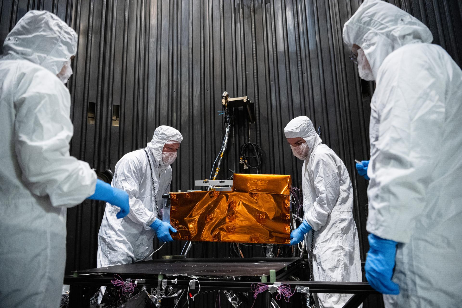 Team members install the Lunar Environment Monitoring Station (LEMS) instrument for testing in a thermal vacuum chamber at Goddard Space Flight Center, Greenbelt Md., March 30, 2026. LEMS is a compact, autonomous, and self-sustaining seismometer suite designed to carry out continuous, long-term, monitoring of the lunar seismic environment at the South Polar region. Photo Credit: NASA/Denny Henry
