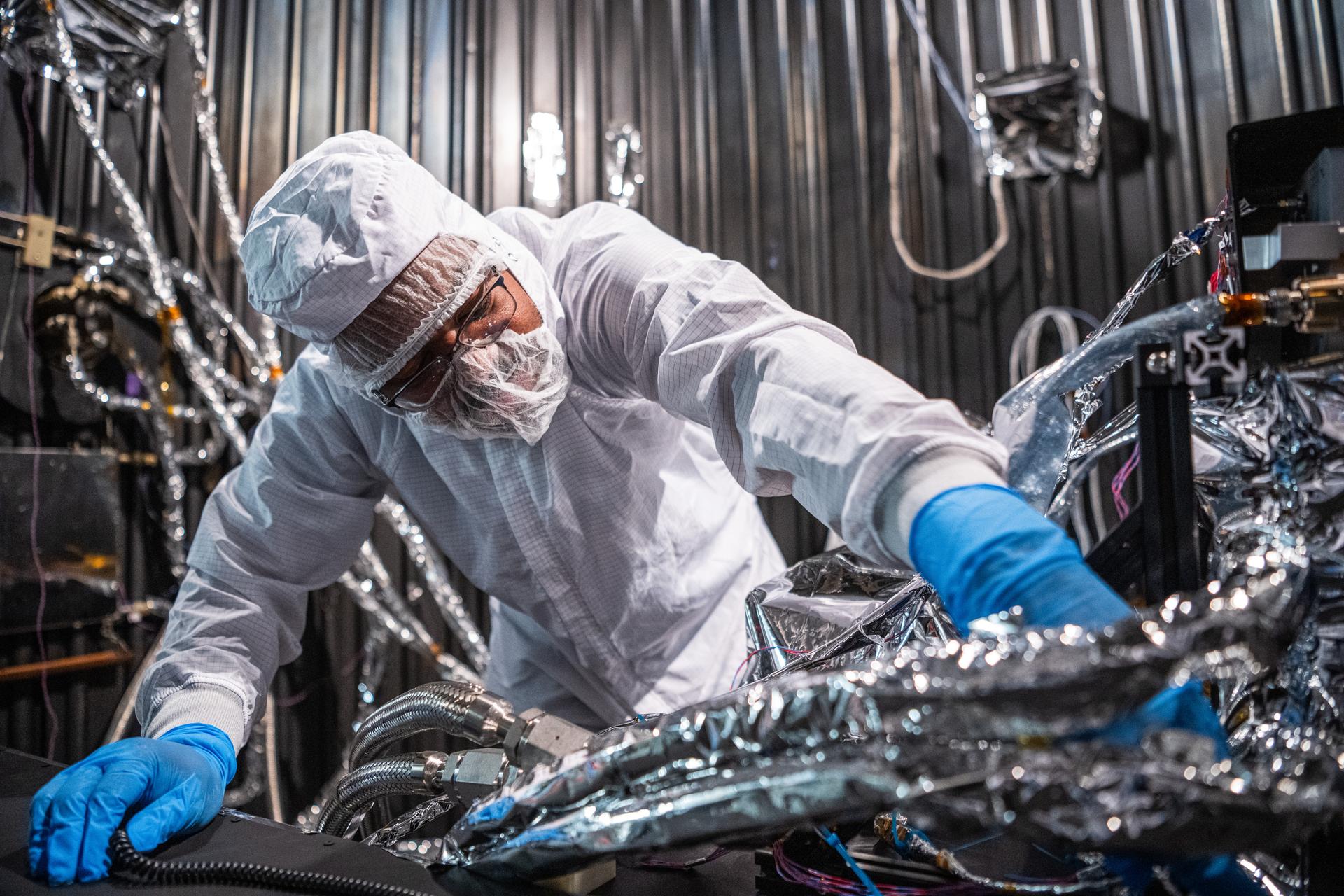 Electrical Systems Lead, James Fraction, inspects the Lunar Environment Monitoring Station (LEMS) instrument in preparation for testing in a thermal vacuum chamber at Goddard Space Flight Center in Greenbelt Md. on April 3rd, 2026. LEMS is a compact, autonomous, and self-sustaining seismometer suite designed to carry out continuous, long-term, monitoring of the lunar seismic environment at the South Polar region. Photo Credit: NASA/Denny Henry