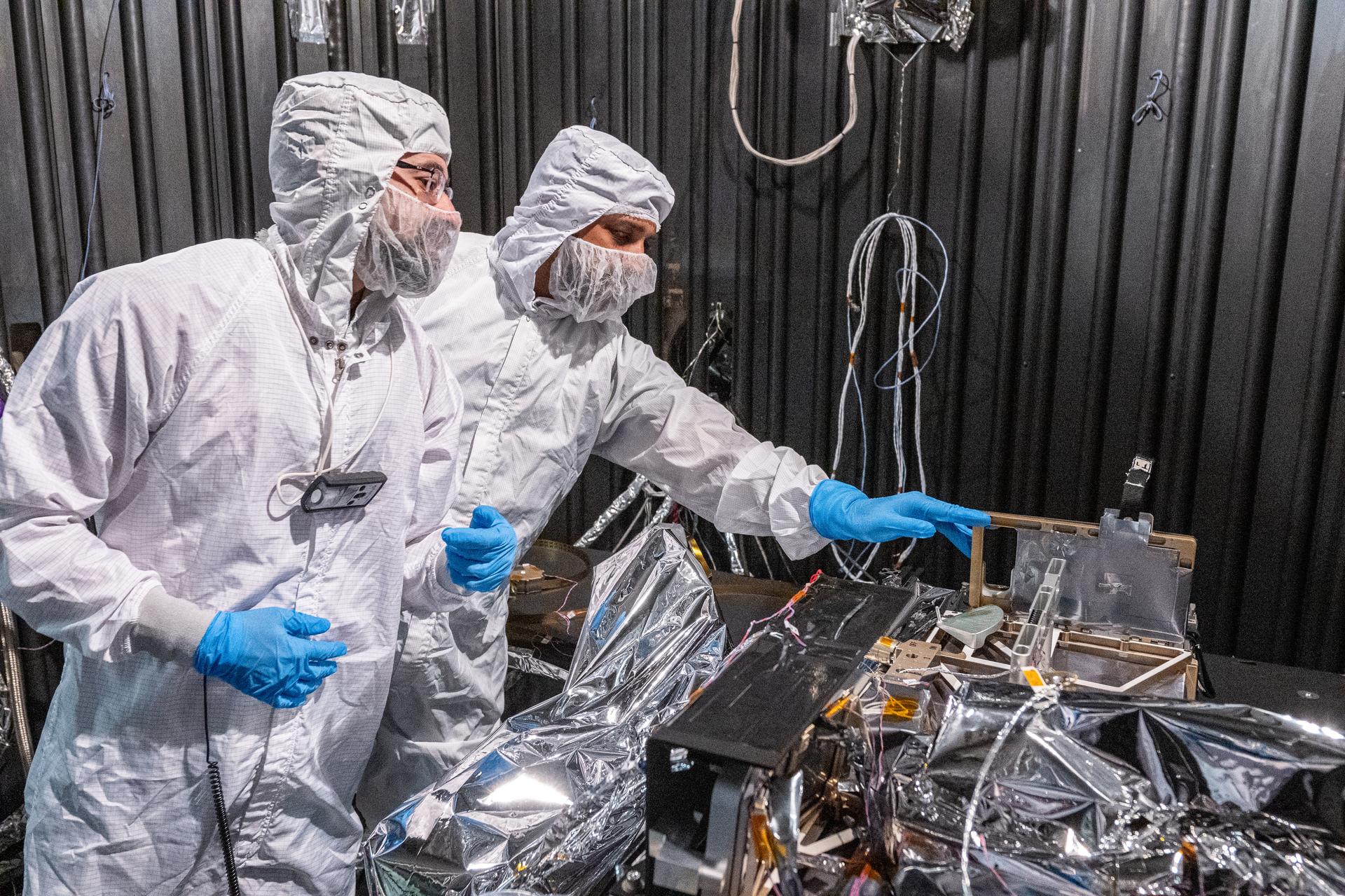 Lead Thermal Engineer Juan Rodriguez-ruiz (left) and Project Manager Neerav Shah inspect the Lunar Environment Monitoring Station (LEMS) instrument in preparation for testing in a thermal vacuum chamber at Goddard Space Flight Center in Greenbelt Md. on April 3rd, 2026. LEMS is a compact, autonomous, and self-sustaining seismometer suite designed to carry out continuous, long-term, monitoring of the lunar seismic environment at the South Polar region. Photo Credit: NASA/Denny Henry
