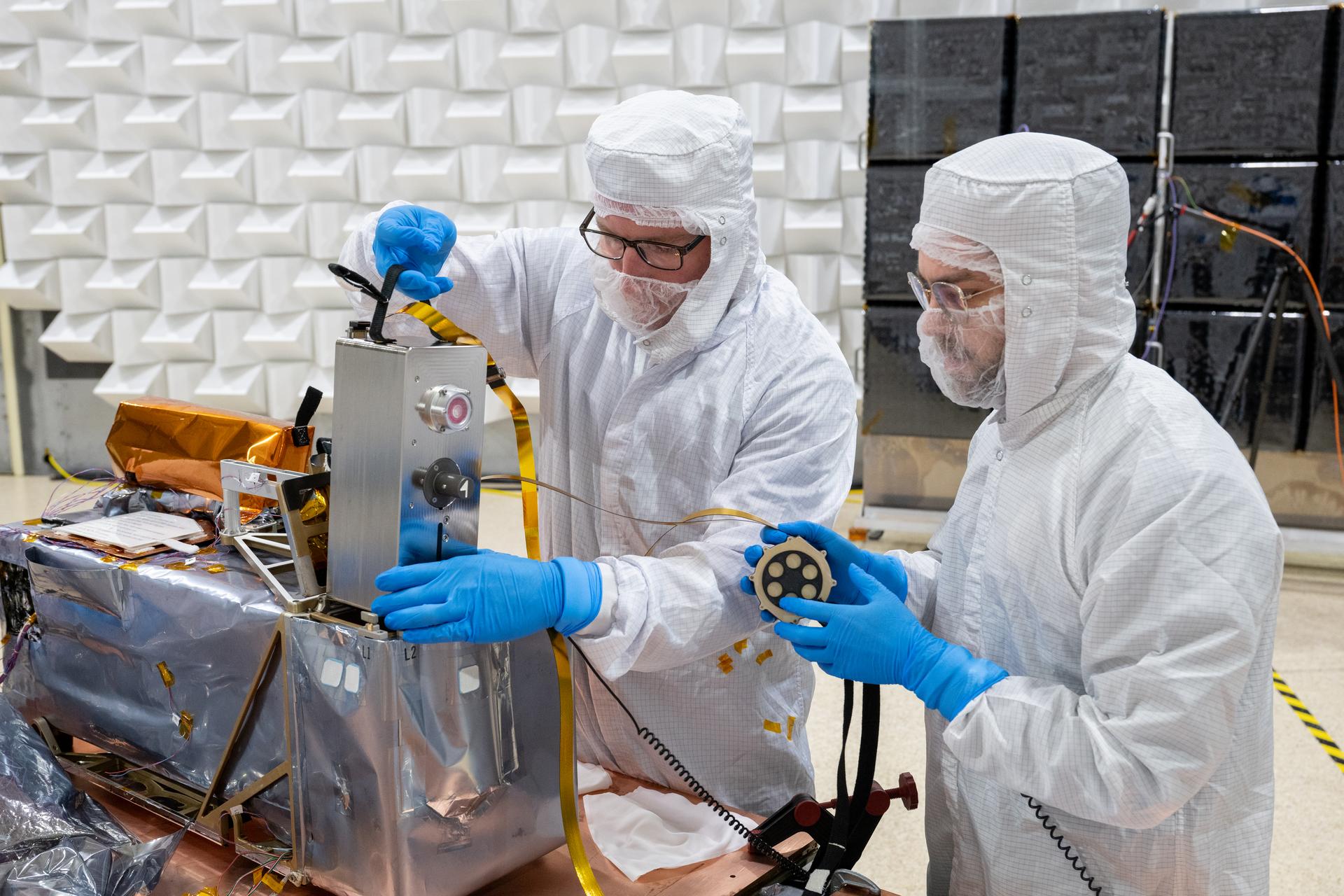 Technician Alex Schaeffer (left), and mechanical engineer Mitchell Hamann stow a seismometer after Electromagnetic Interference testing of the Lunar Environment Monitoring Station (LEMS) instrument at Goddard Space Flight Center, Greenbelt Md., May 15, 2026. LEMS is a compact, autonomous, and self-sustaining seismometer suite designed to carry out continuous, long-term, monitoring of the lunar seismic environment at the South Polar region. Photo Credit: NASA/Desiree Stover