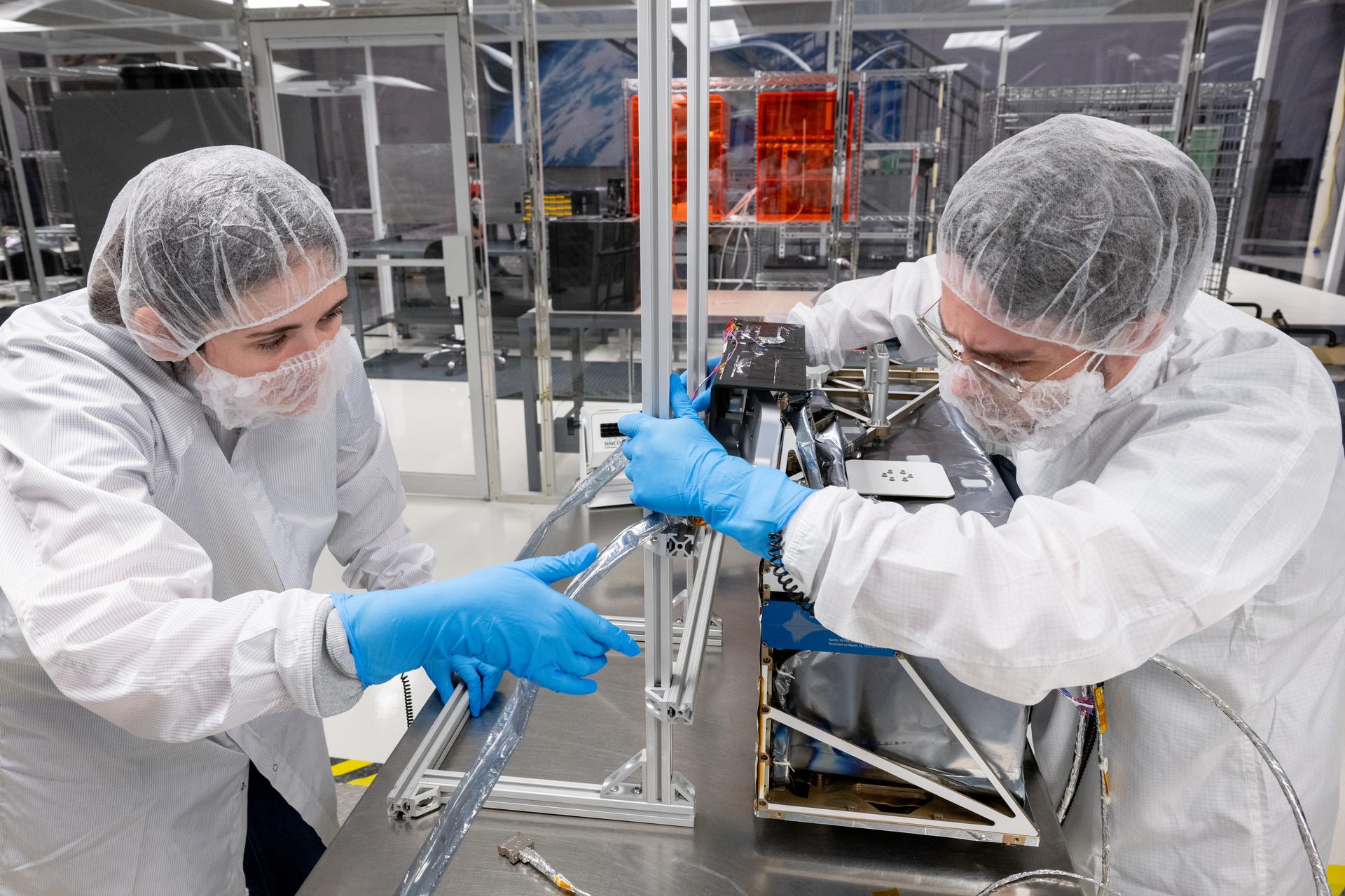 Systems engineer Sam Hicks (left) and mechanical engineer Mitchell Hamann, adjust testing equipment during testing of the Lunar Environment Monitoring Station (LEMS) instrument at the Space Science Center at Morehead State University in Morehead, KY on May 29, 2026. Morehead State University provided LEMS’ telecommunication system and will operate the instrument on the surface. LEMS is a compact, autonomous, and self-sustaining seismometer suite designed to carry out continuous, long-term, monitoring of the lunar seismic environment at the South Polar region. Photo Credit: NASA/Desiree Stover