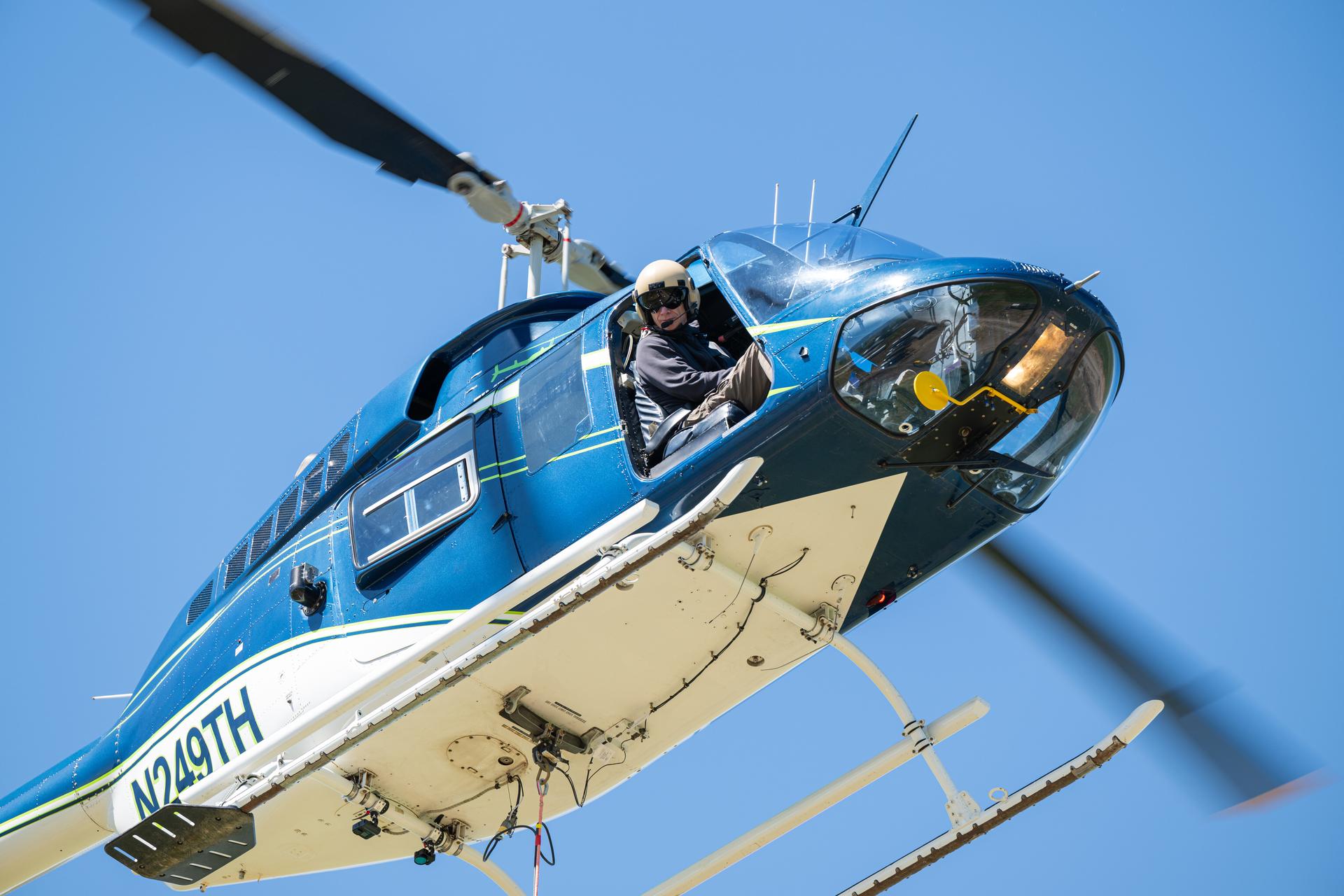 Joe Turner, a pilot with Timberland Helicopters, looks out the window of their helicopter while performing test flights with NASA's DAVINCI VADIX prototype tethered to the helicopter. VADIX is a prototype of a camera system which will one day fly on NASA's DAVINCI mission to Venus. NASA/Mike Guinto