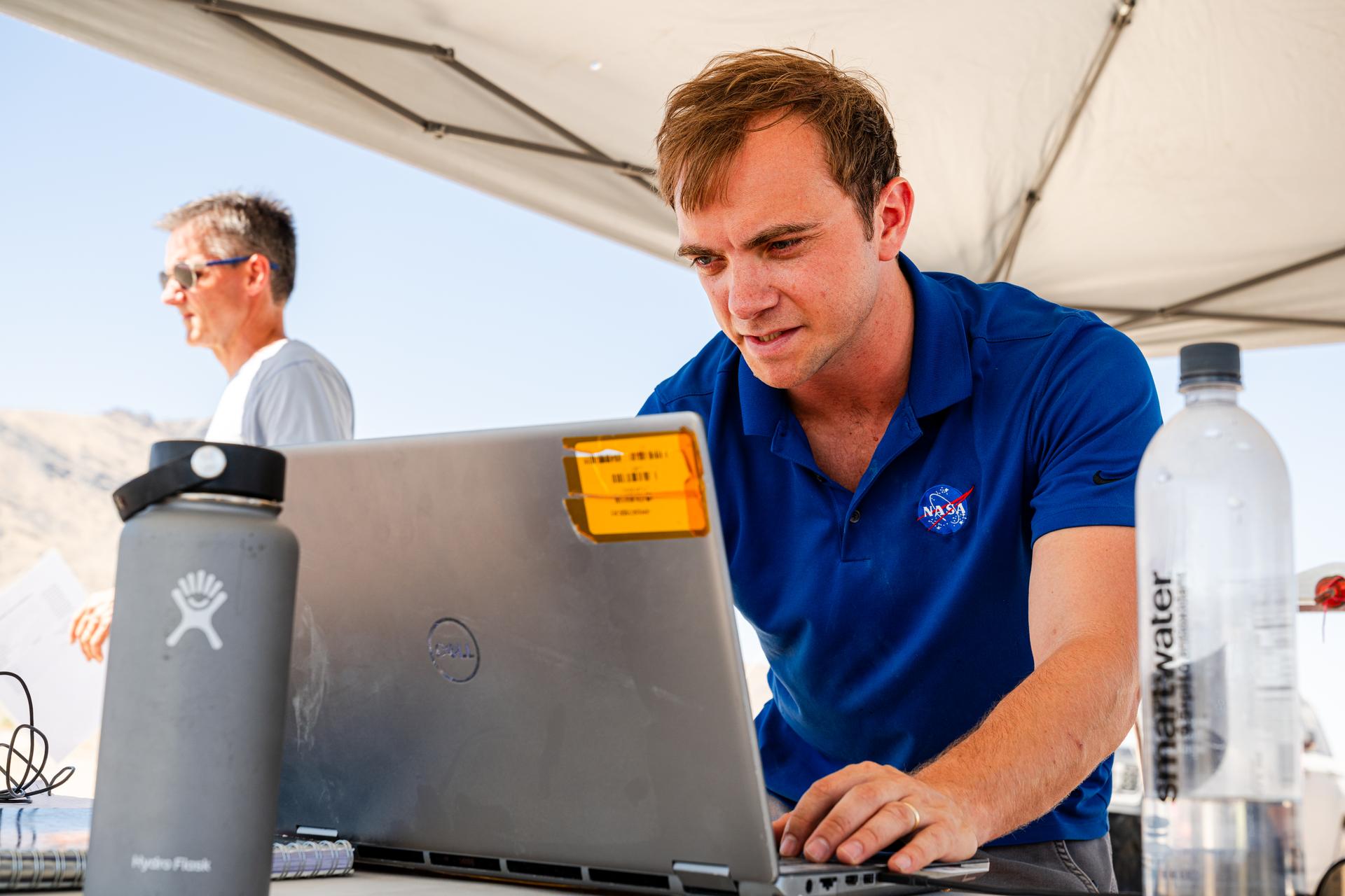 DAVINCI's Matthew Mullin, space laser engineer, reviews data in between test flights at Crater Island, Utah June 24, 2026. NASA/Mike Guinto