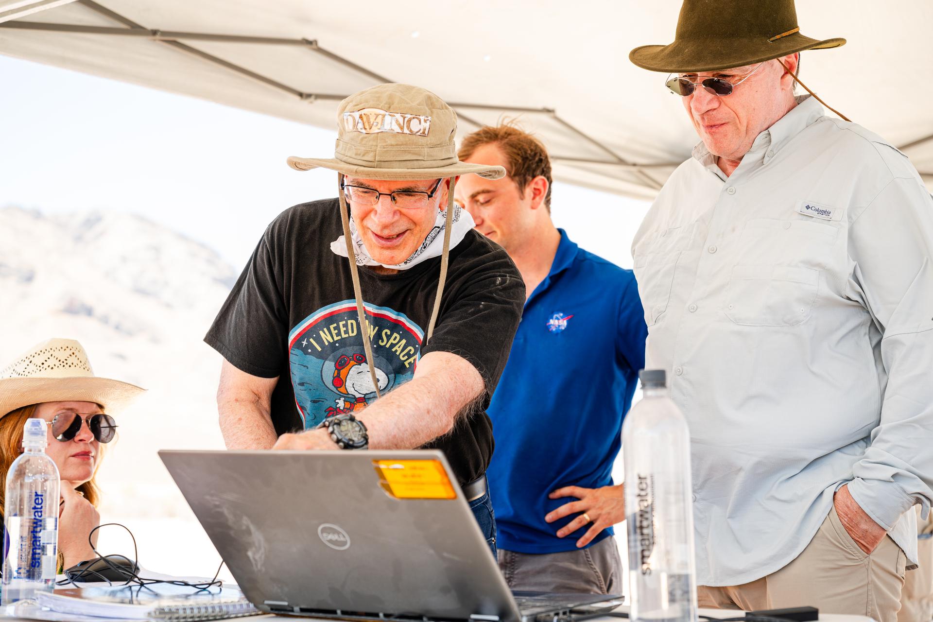 Dr. Jim Garvin, left, and Mike Ravine review flight data inbetween test flights over Crater Island, Utah as part of the DAVINCI VADIX experiment, June 24, 2026. NASA/Mike Guinto