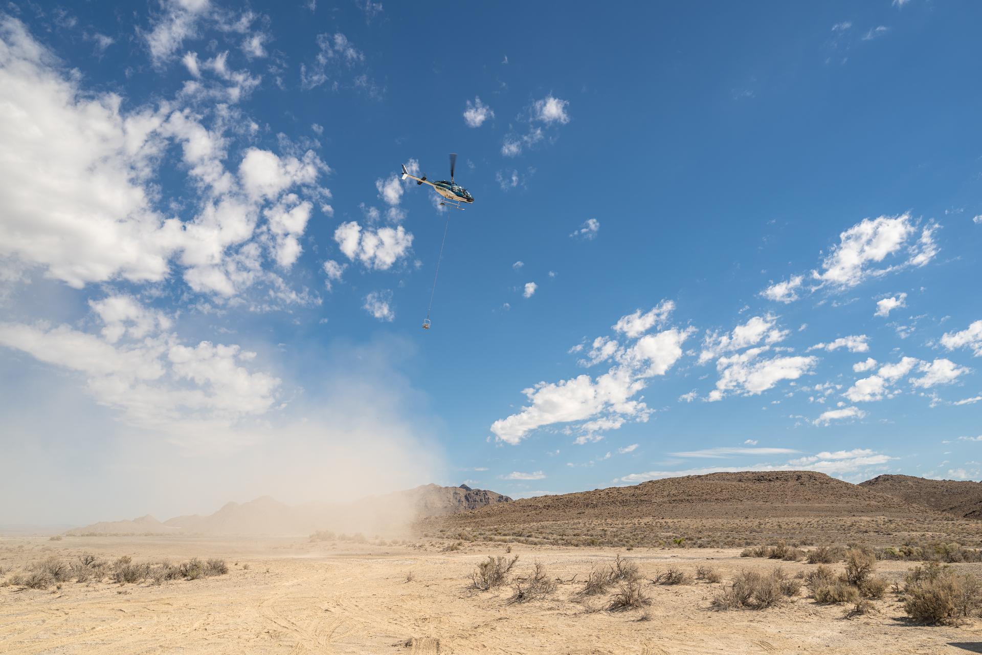 A helicopter flying in U.S. Air Force restricted space over Crater Island, Utah, carrying a basket of nine instruments during a series of tests (June 23-25, 2026) of a prototype of the camera system that will one day fly aboard NASA’s DAVINCI probe to Venus. NASA/Mike Guinto