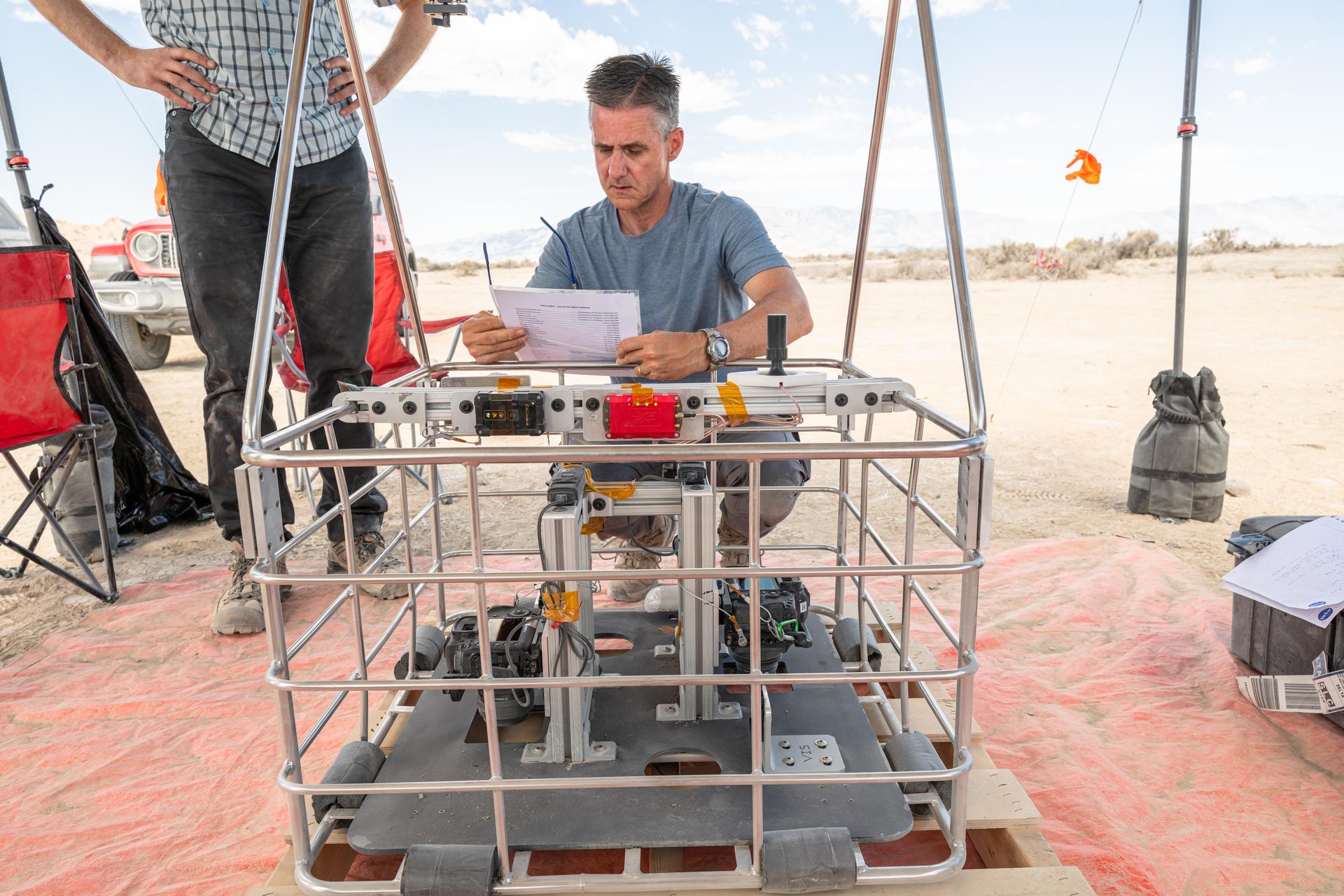 Brent Bos, a research physicist at NASA’s Goddard Space Flight Center in Greenbelt, Maryland, does a pre-flight check of a basket of instruments before one of the 10 high-altitude test flights at Crater Island, Utah. This area was the site of a series of tests (June 23-25, 2026) of the camera system that will one day fly aboard NASA’s DAVINCI mission probe to Venus.