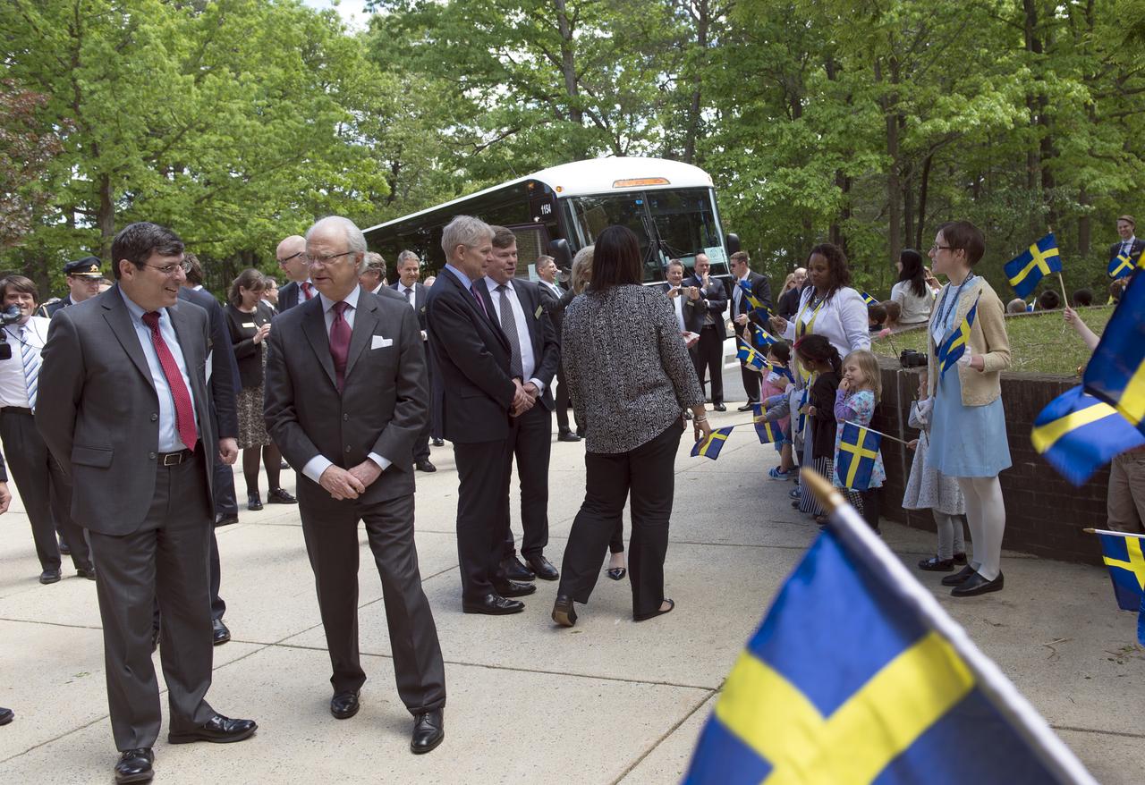 Swedish Delegation visited Goddard on May 3, 2017.  Center Director Chris Scolese greets His Majesty Carl XVI Gustaf, King of Sweden at Bldg 28.  For arrival children from the Goddard Child Development Center greeted him with flag, flowers and a painting of Swedish Linnea flower as a gift.