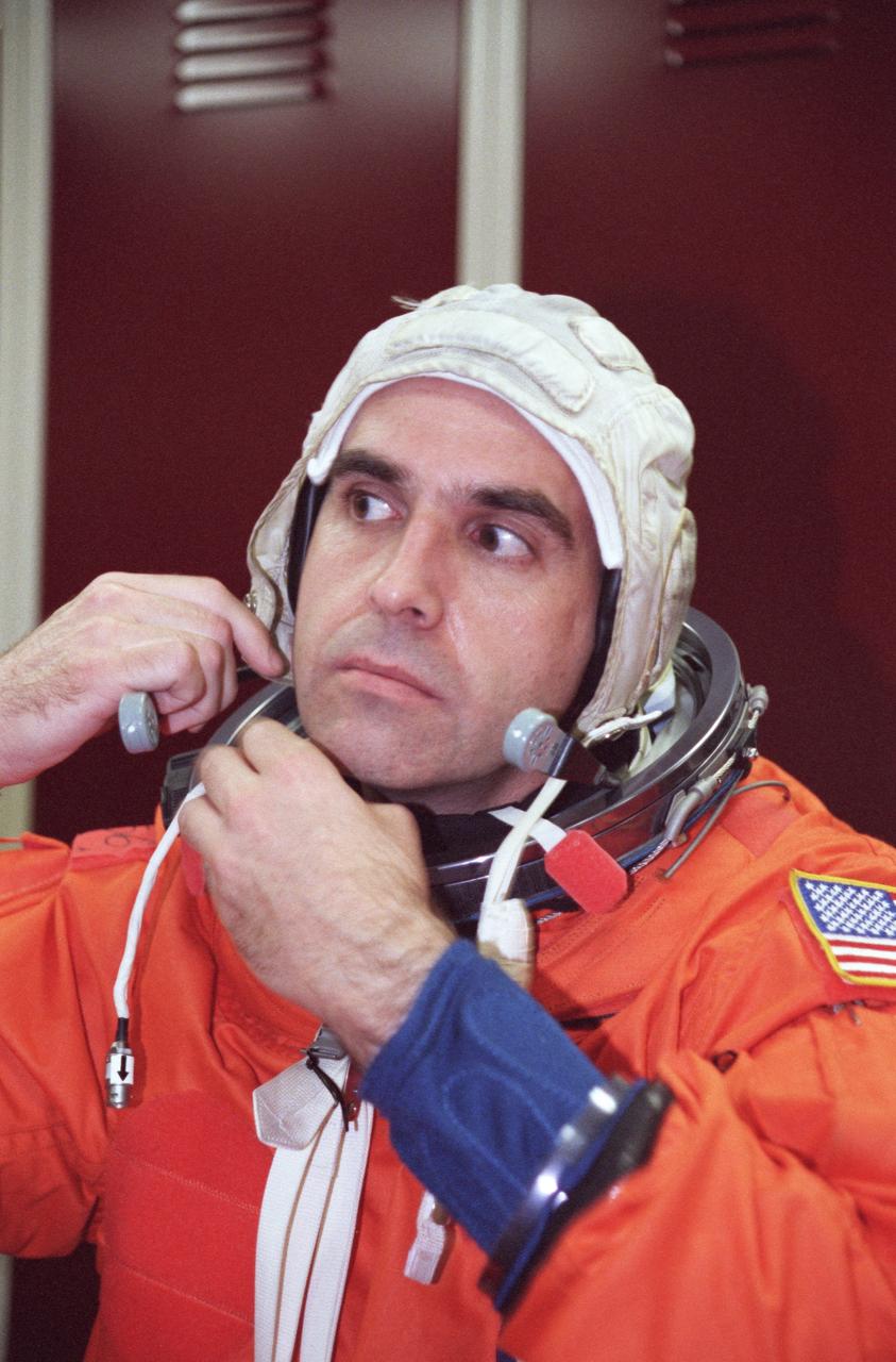 JSC2000-02219 (March 2000) --- Astronaut Richard A. Mastracchio, mission specialist, fastens his communications carrier assembly (CCA), part of the  launch and entry suit (LES), during a training session at the Johnson Space  Center's Systems Integration Facility.