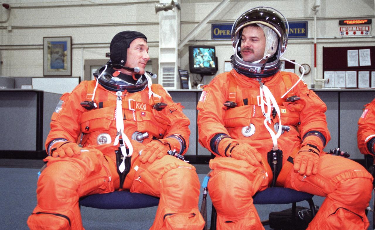 JSC2000-02933 (5 April 2000) --- Astronauts Terrence W. (Terry) Wilcutt  (left), mission commander, and Scott D. Altman, pilot, await ingress of a crew  training mockup to begin an emergency egress training session at the Johnson Space Center (JSC).  The two will join  three other NASA astronauts and two cosmonauts representing the Russian  Aviation and Space Agency for a late summer visit to the International Space Station (ISS).