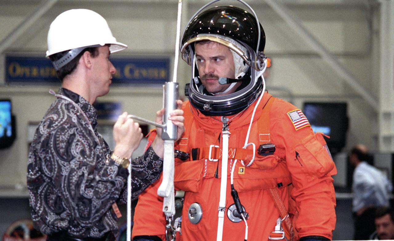 JSC2000-02935 (5 April 2000) --- David Pogue (left), a crew escape equipment  trainer, helps astronaut Scott D. Altman  with a special device that enables him to rappel from an Earthbound shuttle in trouble.  The STS-106 pilot will join four other NASA astronauts and two cosmonauts representing the Russian Aviaition and Space Agency for a late summer visit to the International Space Station.