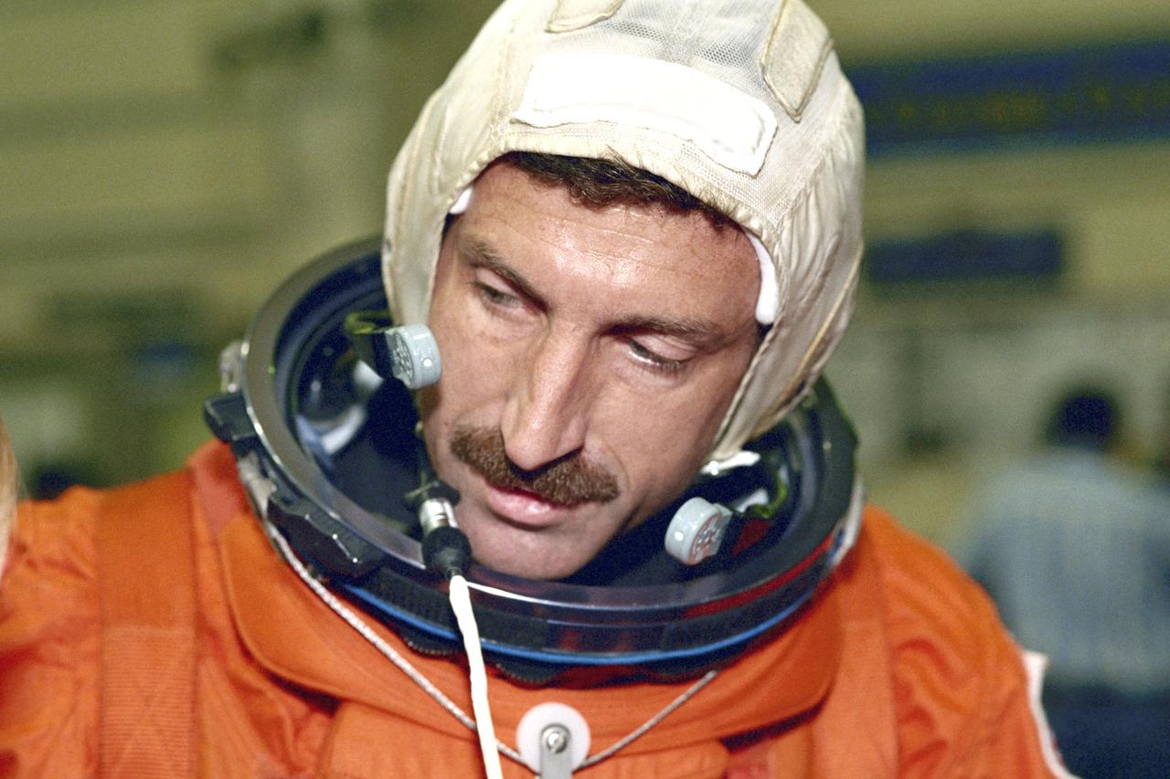 JSC2000-03345 (19 April 2000) --- Astronaut Daniel C. Burbank, STS-106 mission specialist, checks his communication gear during suit-donning prior to a training exercise at JSC's Systems Integration Facility.  The  mission specialist is scheduled to join four other NASA astronauts and two Russian cosmonauts for a late summer mission to the International Space Station.