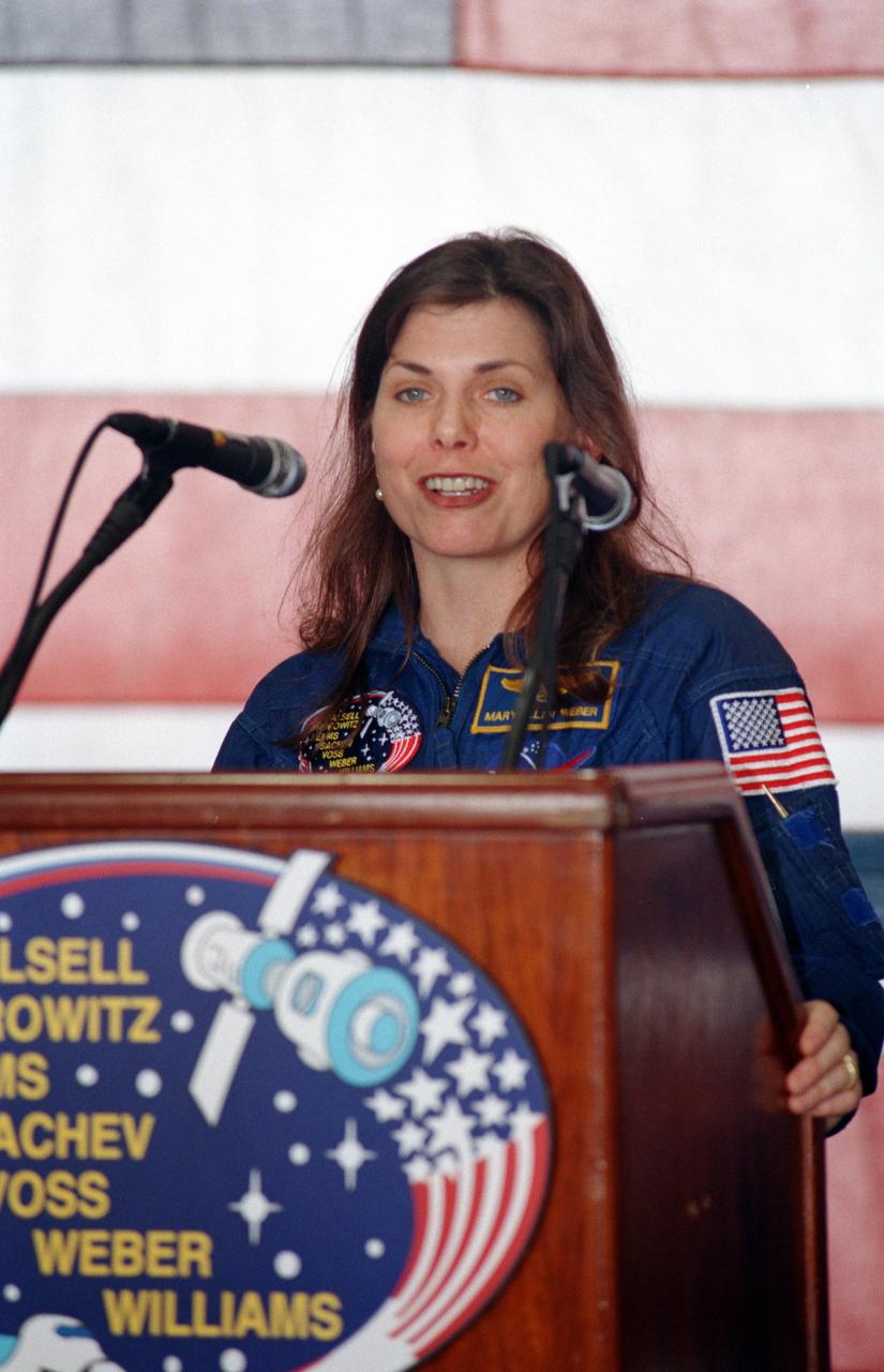 JSC2000-04605 (30 May 2000) --- Astronaut Mary Ellen Weber, mission specialist, speaks to a crowd at the crew-welcoming ceremony at Ellington Field on the day following the completion of the STS-101 mission.