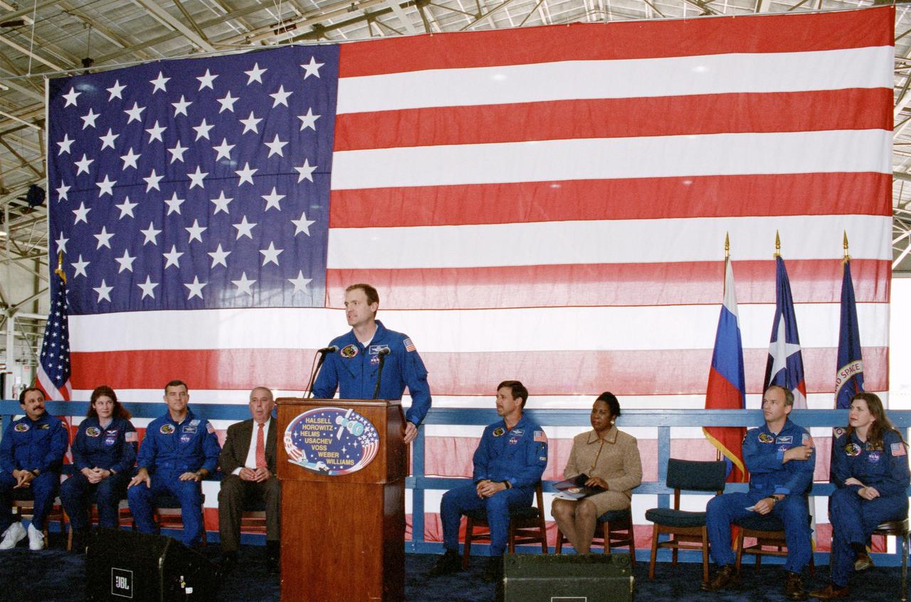 JSC2000-04607 (30 May 2000) --- Astronaut James D. Halsell, Jr., mission commander, speaks to a crowd at the crew-welcoming ceremony at Ellington Field on the day following the completion of the STS-101 mission.  Other speakers, seated behind the lecturn, are (from the left) cosmonaut  Yury V. Usachev, representing the Russian Aviation and Space Agency;  Susan J. Helms and James S. Voss, all mission specialists; JSC Director  George W.S. Abbey; astronaut Scott J. Horowitz, pilot; U.S. Congresswoman Sheila Jackson Lee (D.-Houston); along with astronauts Jeffrey N. Williams and Mary Ellen Weber, both mission specialists.