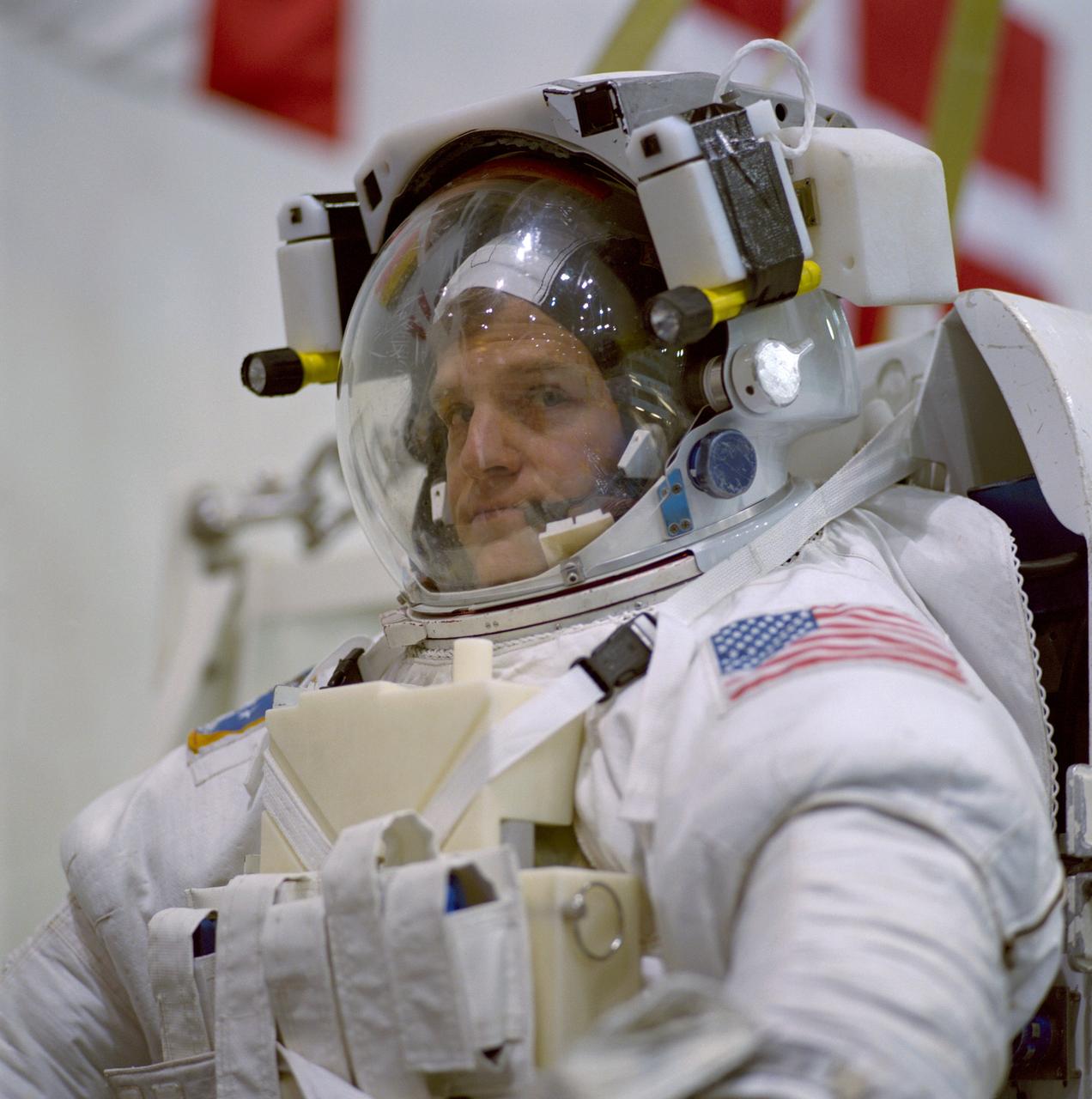 JSC2000-07396 (1 Dec. 2000) --- Astronaut Scott E. Parazynski, mission specialist, is about to be submerged in a giant pool of water in order to simulate spacewalk chores scheduled for next year's STS-100 visit to the International Space Station (ISS). Astronaut Chris A. Hadfield (out of frame) joined Parazynski for the rehearsal.